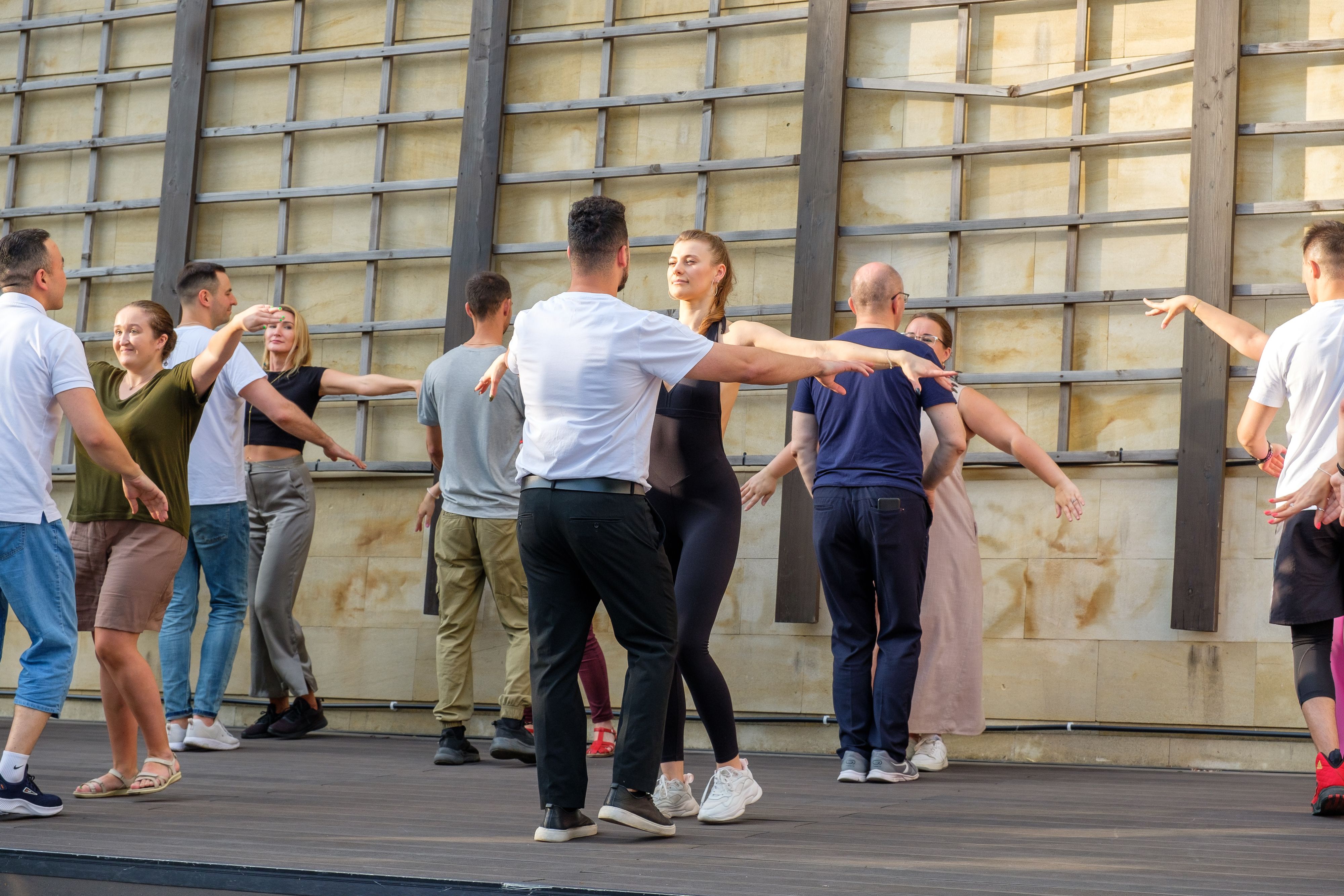Beautiful couples dance bachata on the street dance floor.