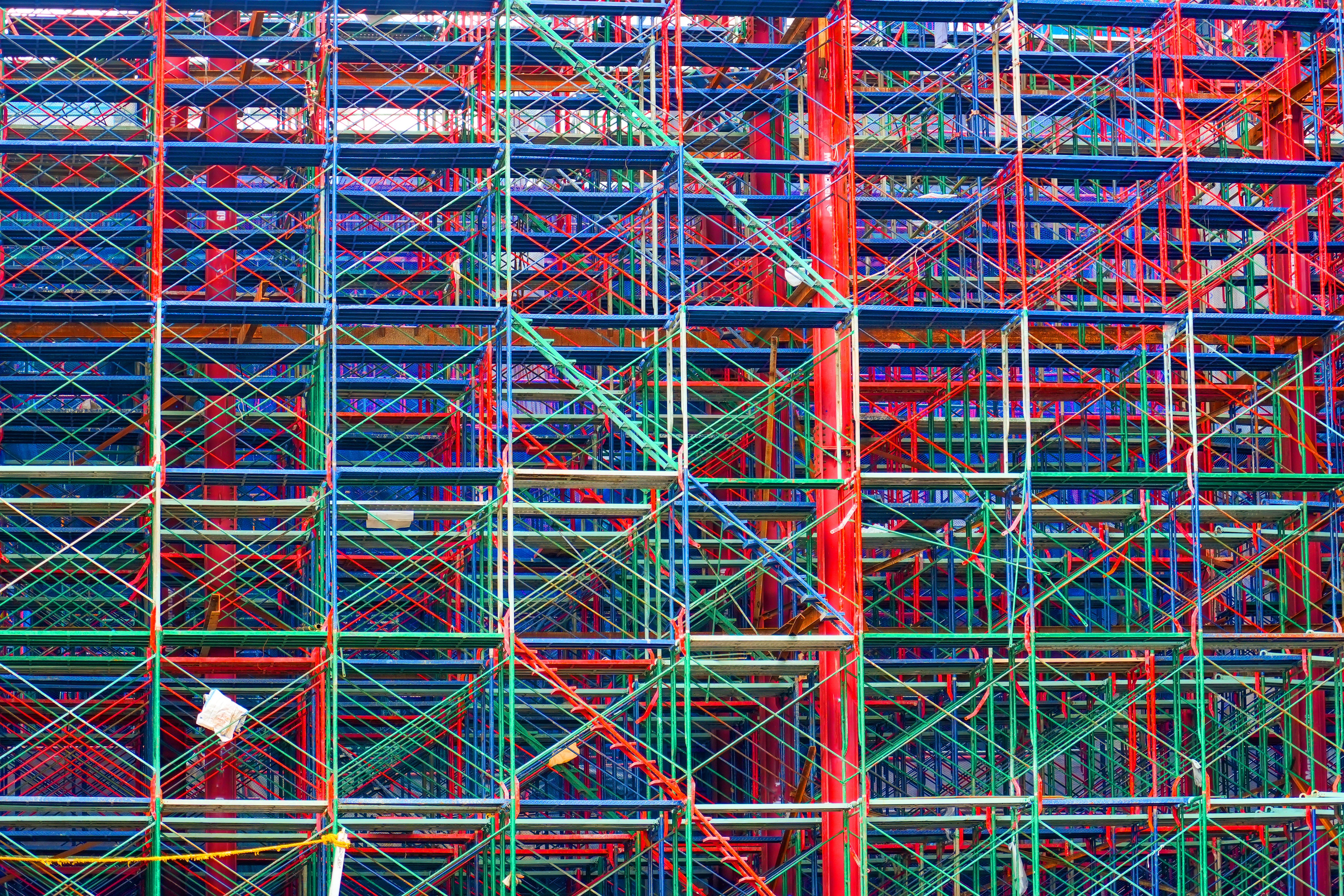 Scaffolding red blue on a construction site of a new building