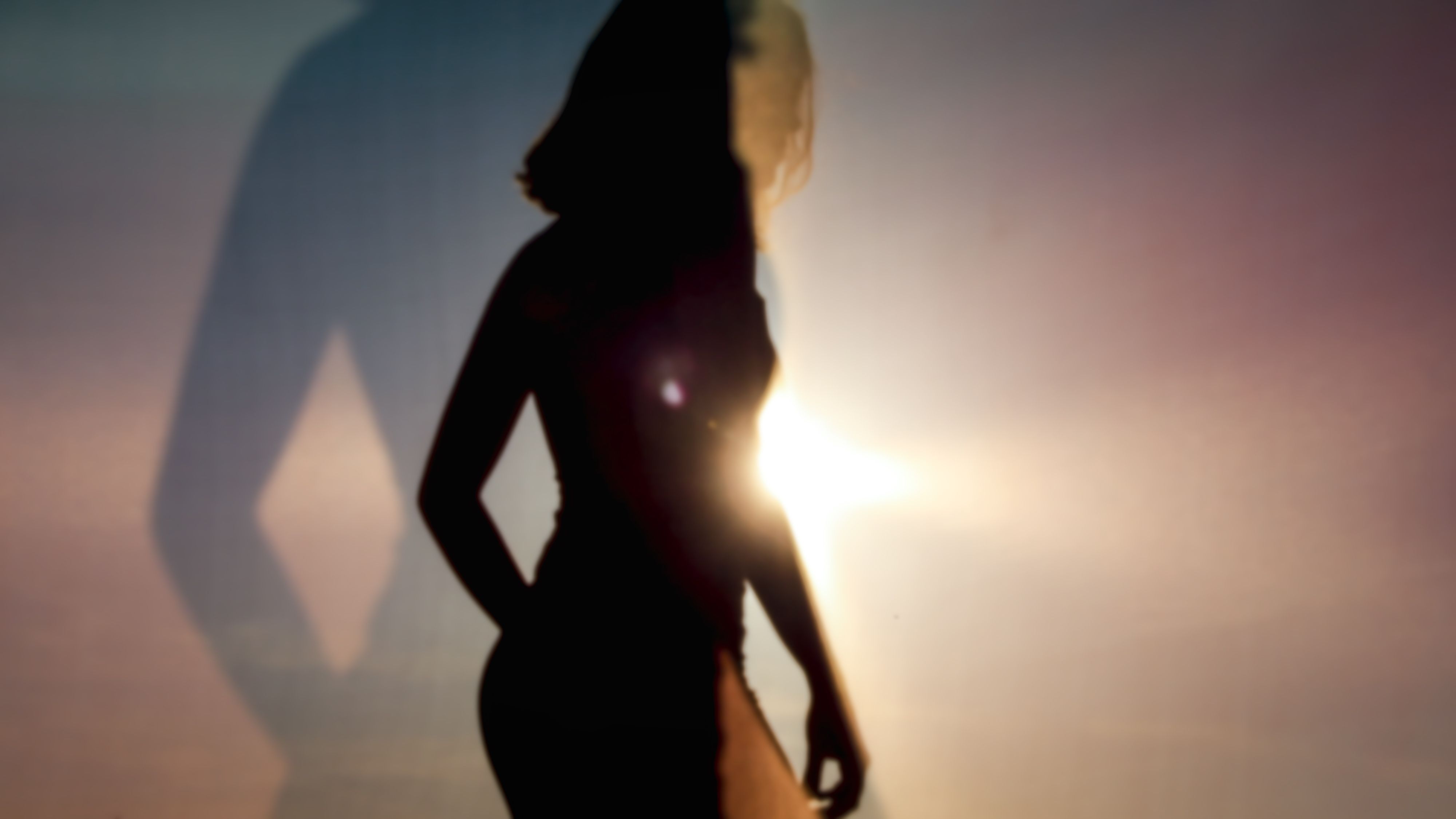 silhouette of woman at sunset