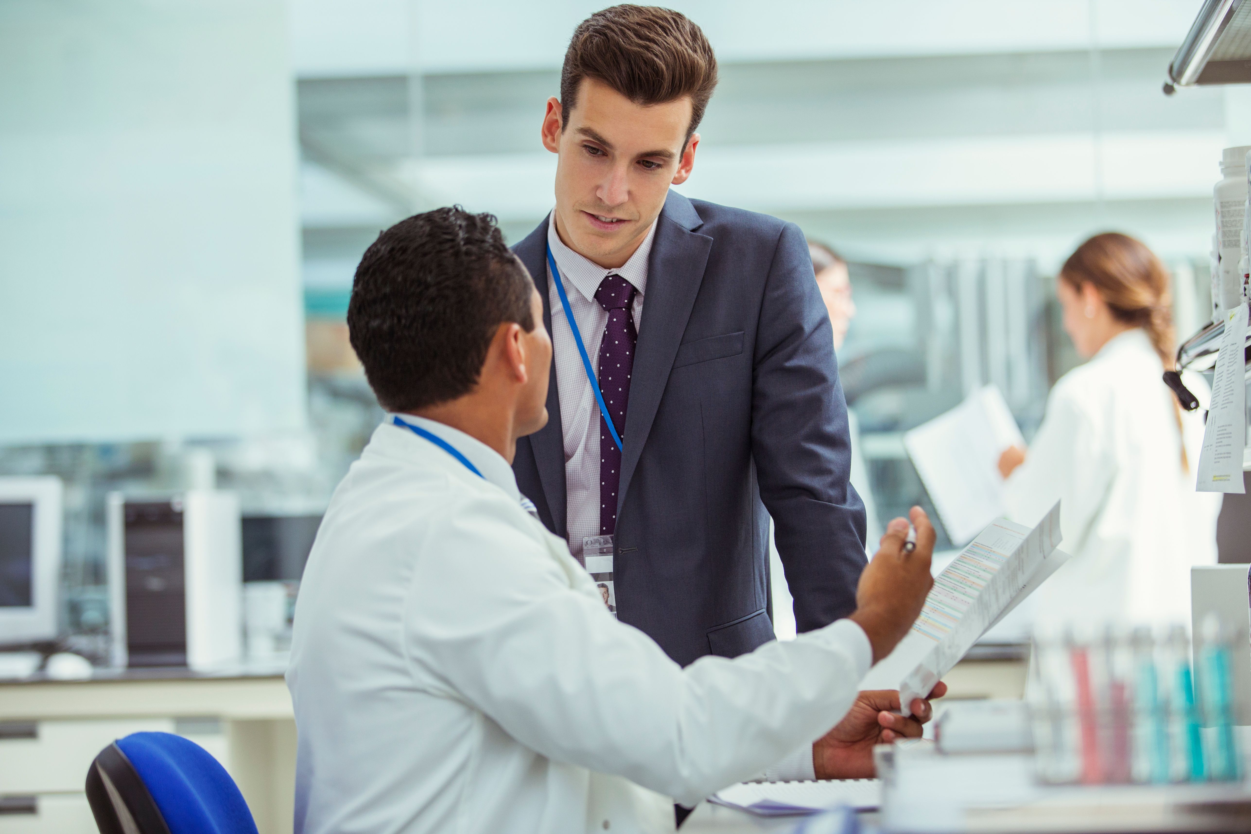 Scientist and businessman talking in laboratory