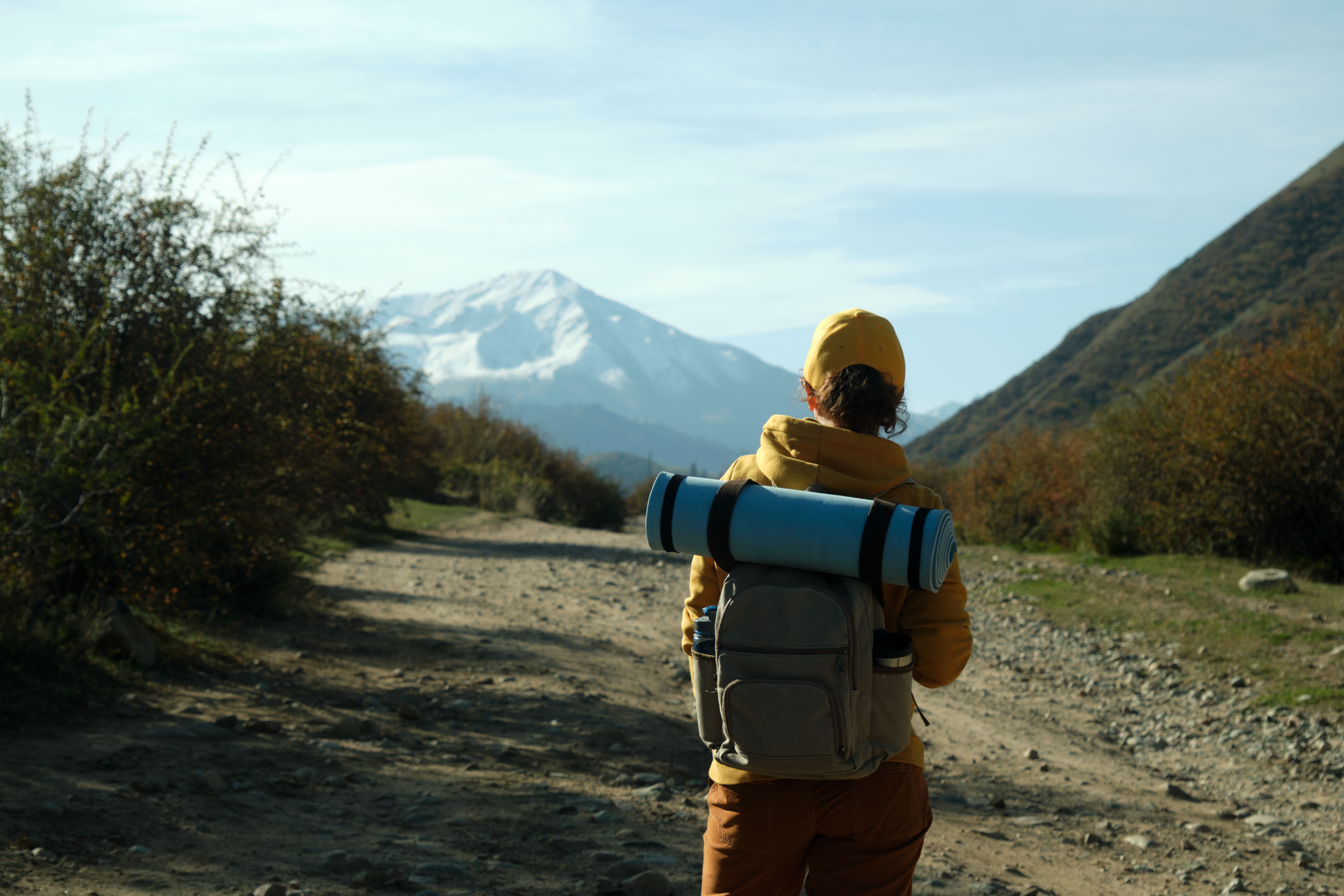 45 year old female hiker is standing in autumn mountain gorge and looking at view 45 year old female hiker is standing in autumn mountain gorge and looking at view