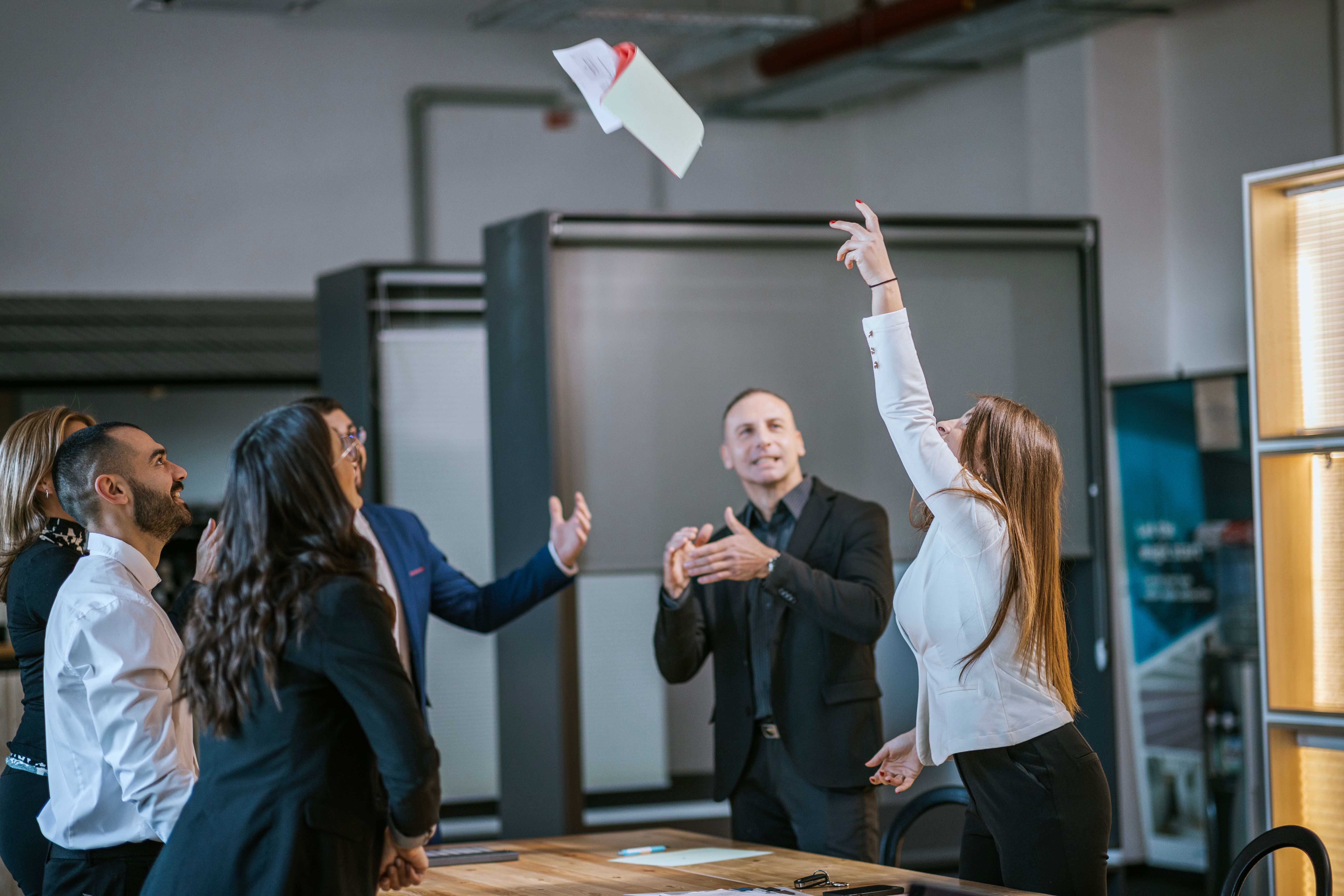 Colleagues celebrating success with enthusiasm during a business meeting in the office