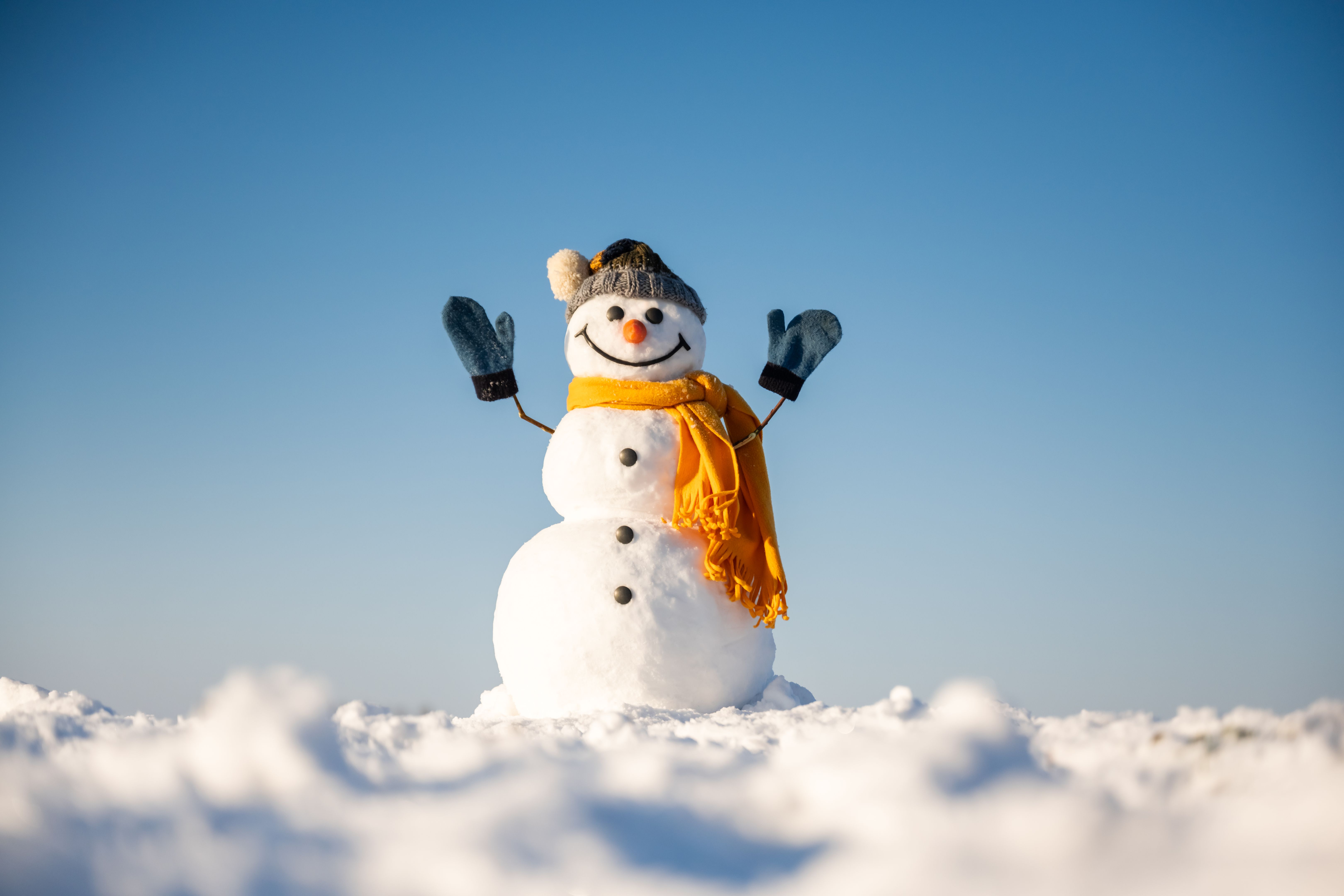Funny snowman in knitted hat