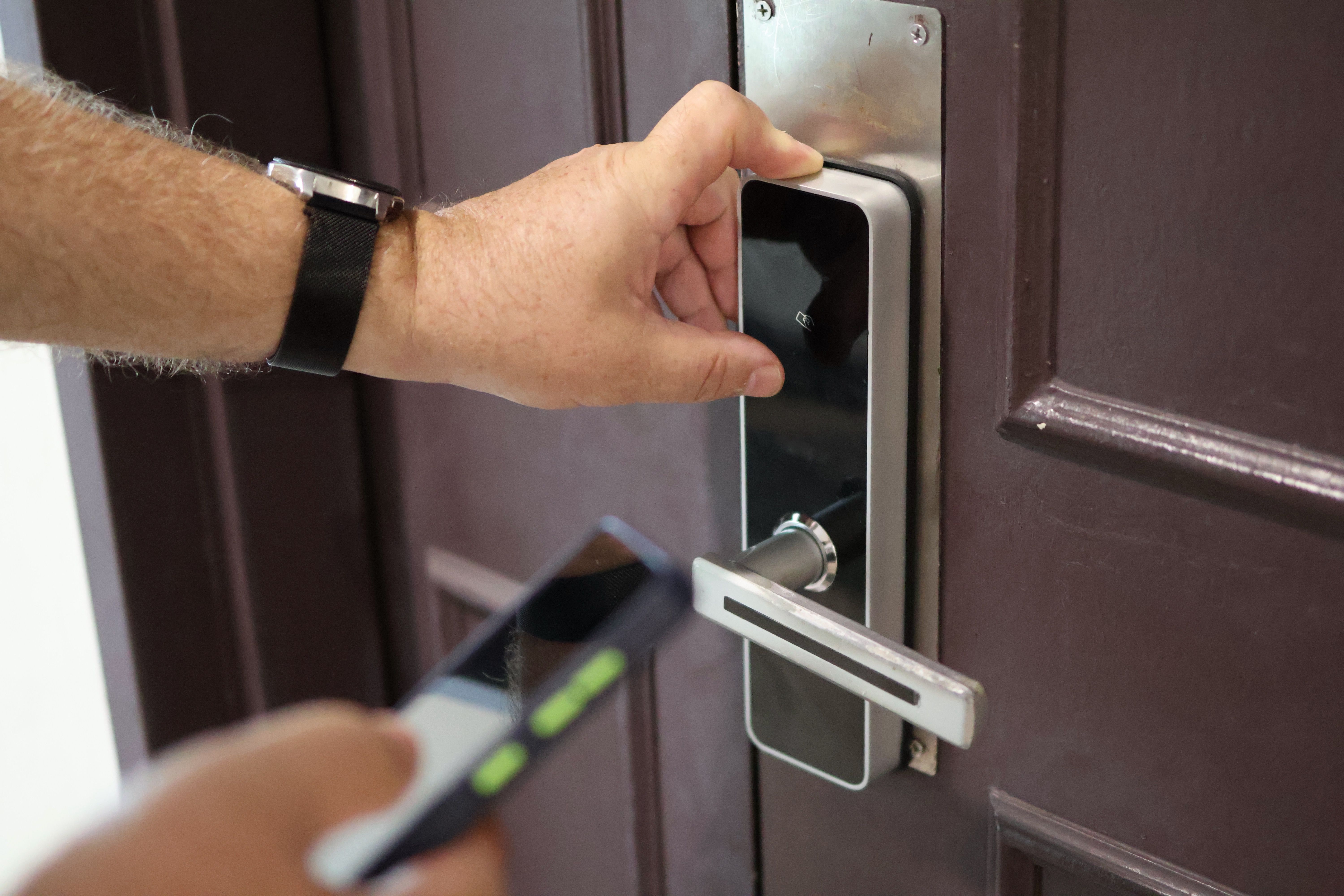 Man opens door to hotel room