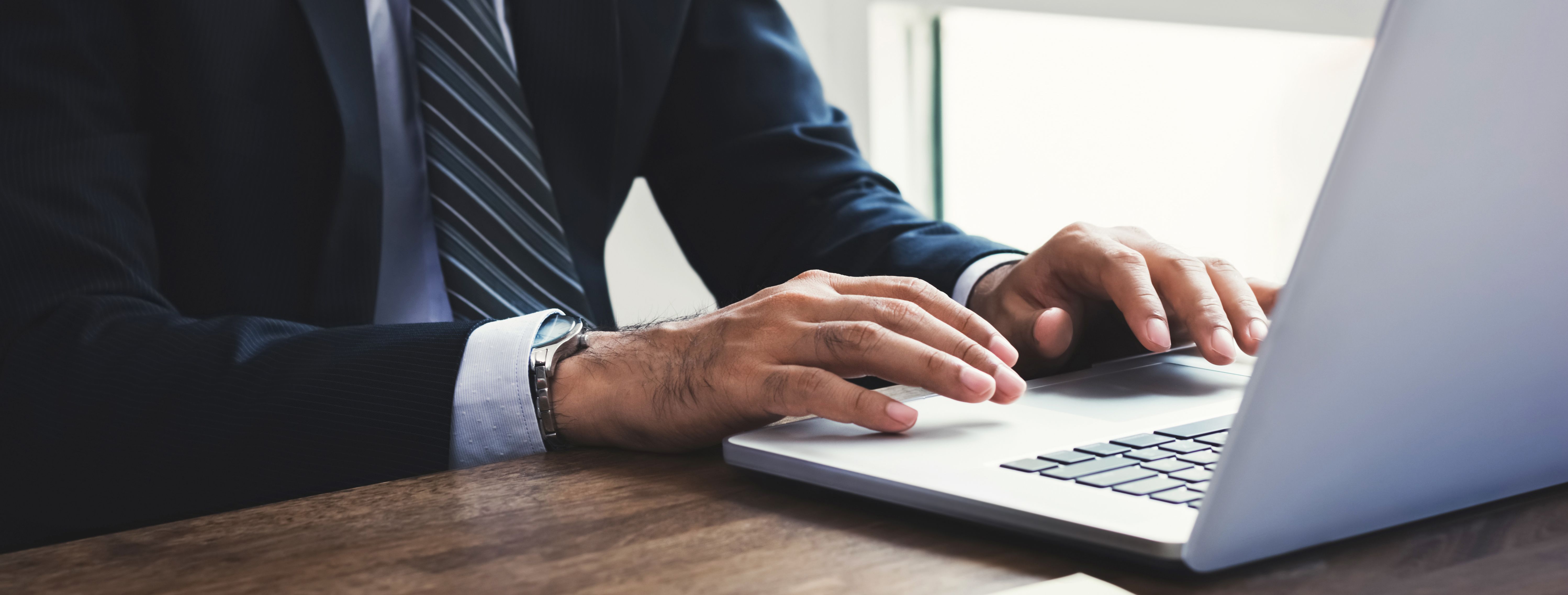 Businessman working on laptop computer at office