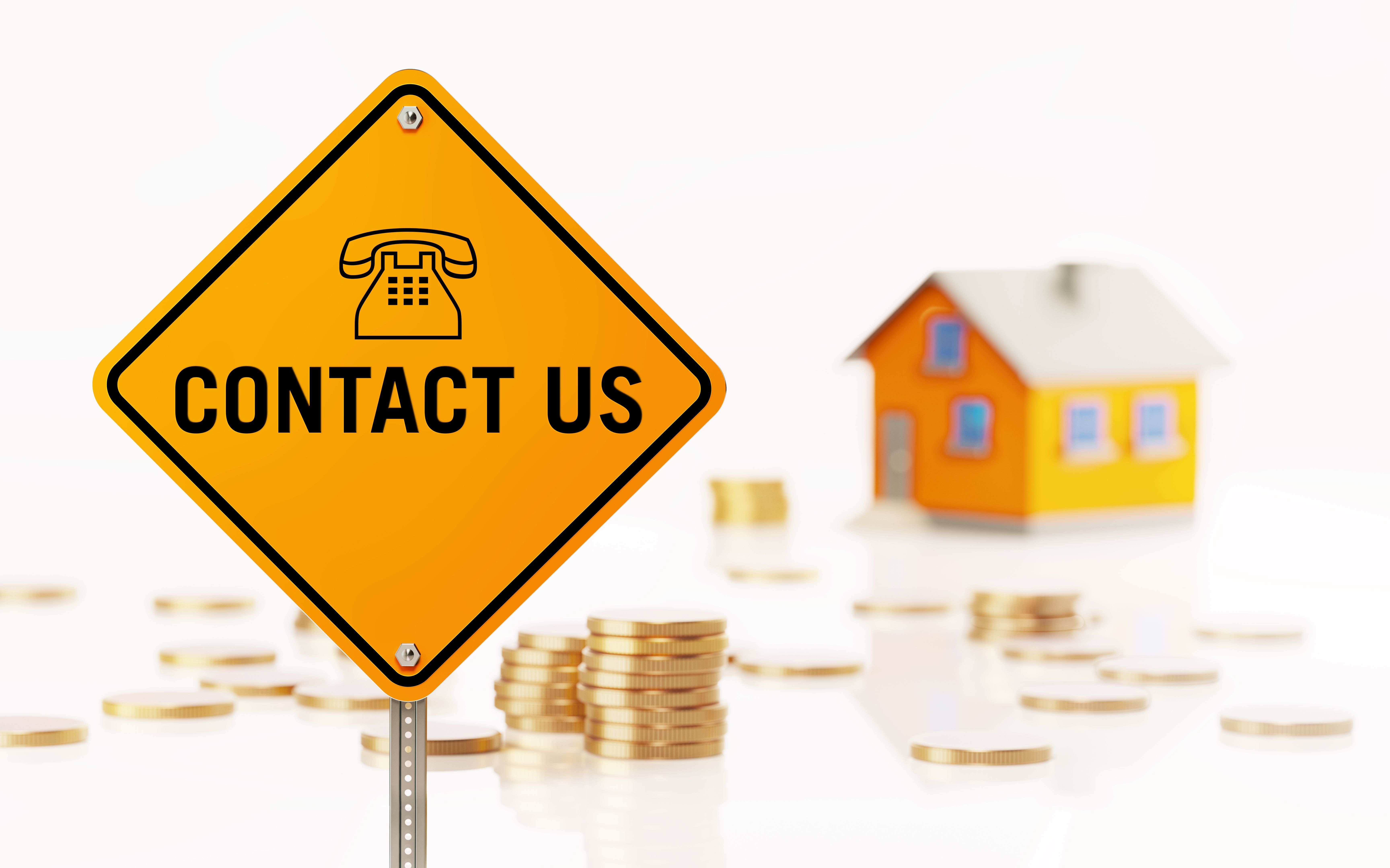 Yellow Road Sign in Front of Yellow Toy House: Real Estate Concept