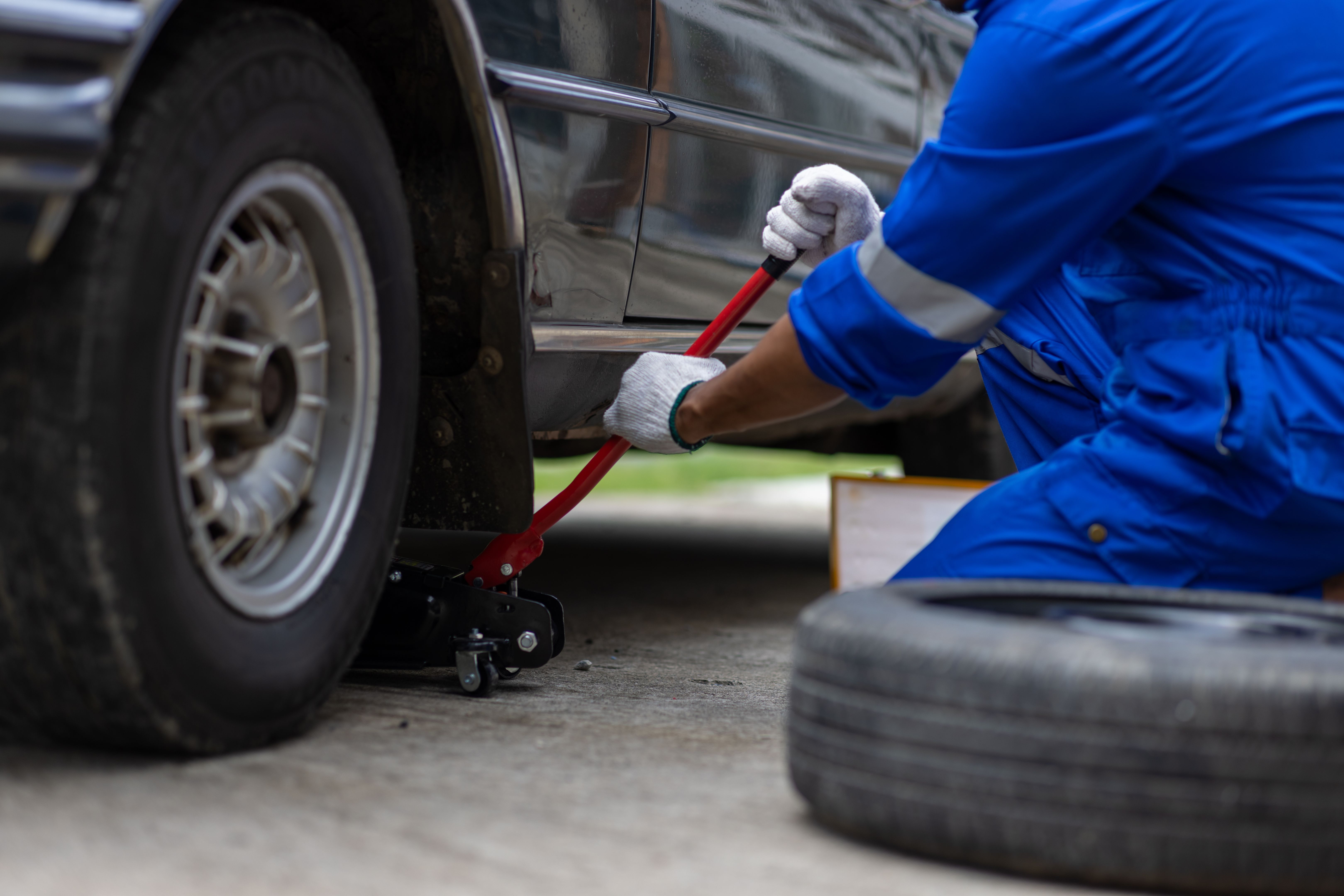 mechanic using hydraulic jack