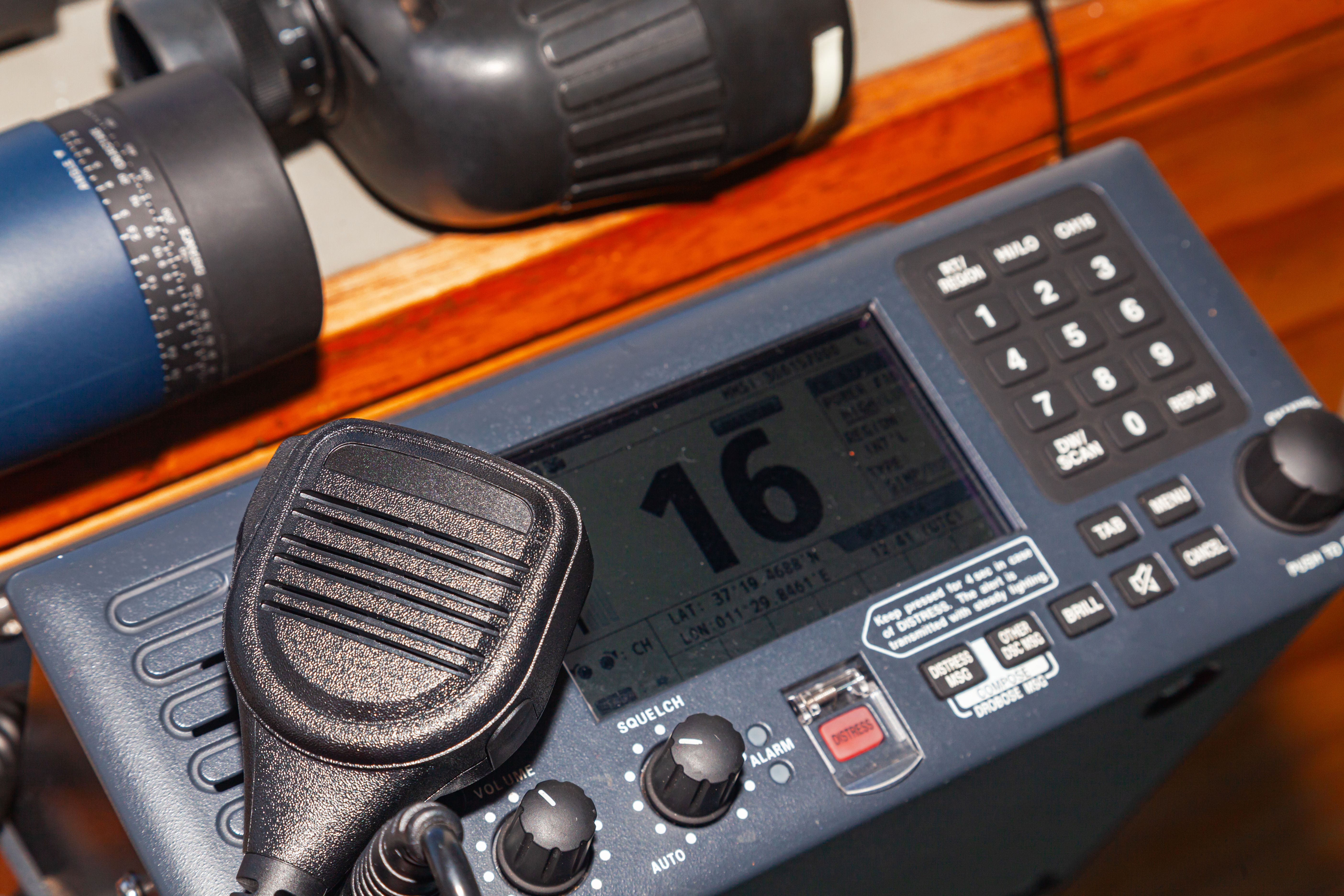 Professional working long-range walkie-talkie with binoculars on the table. Professional working long-range walkie-talkie with binoculars on the table.