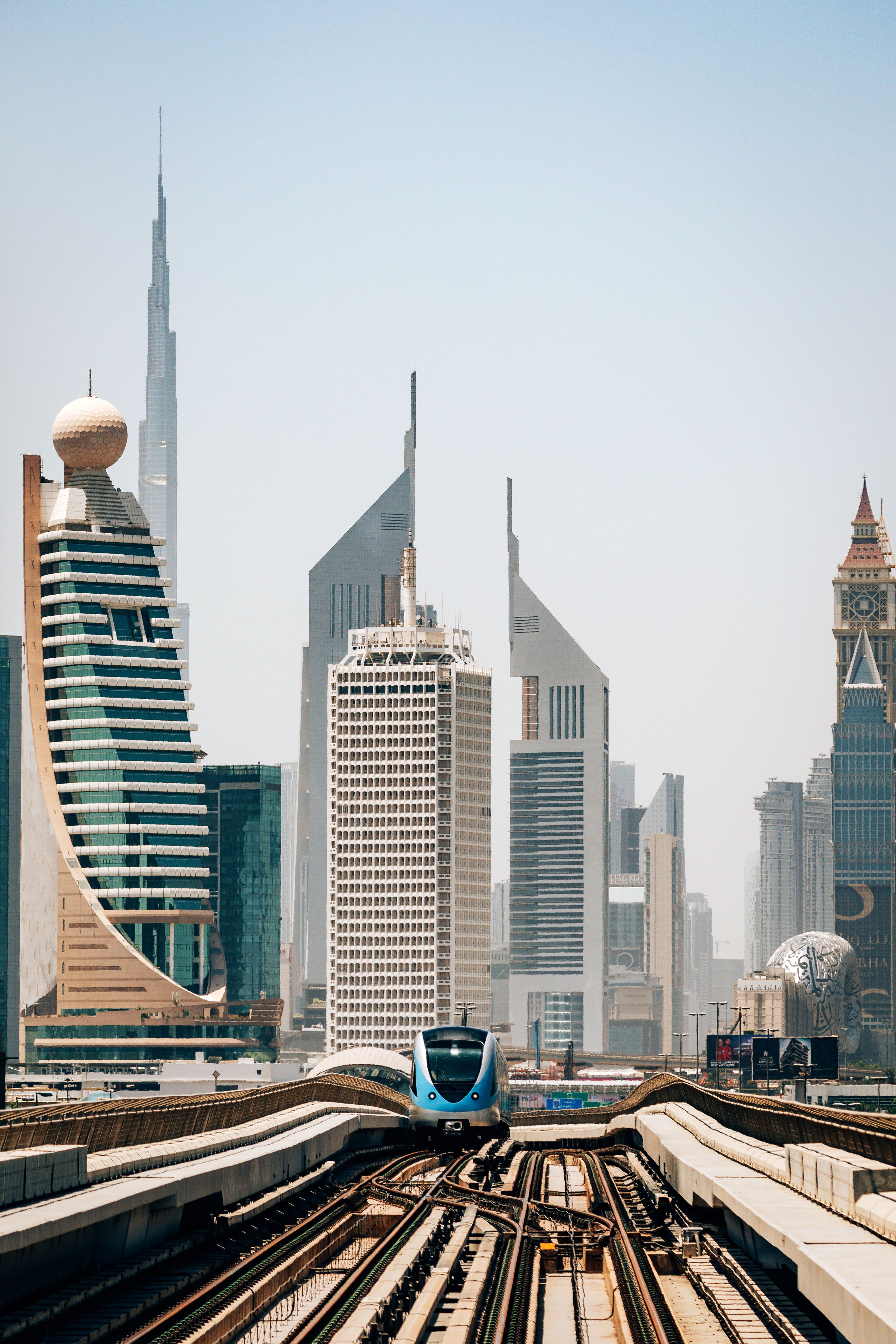 Modern Subway Train on Tracks Surrounded by Dubai Skyline Skyscrapers