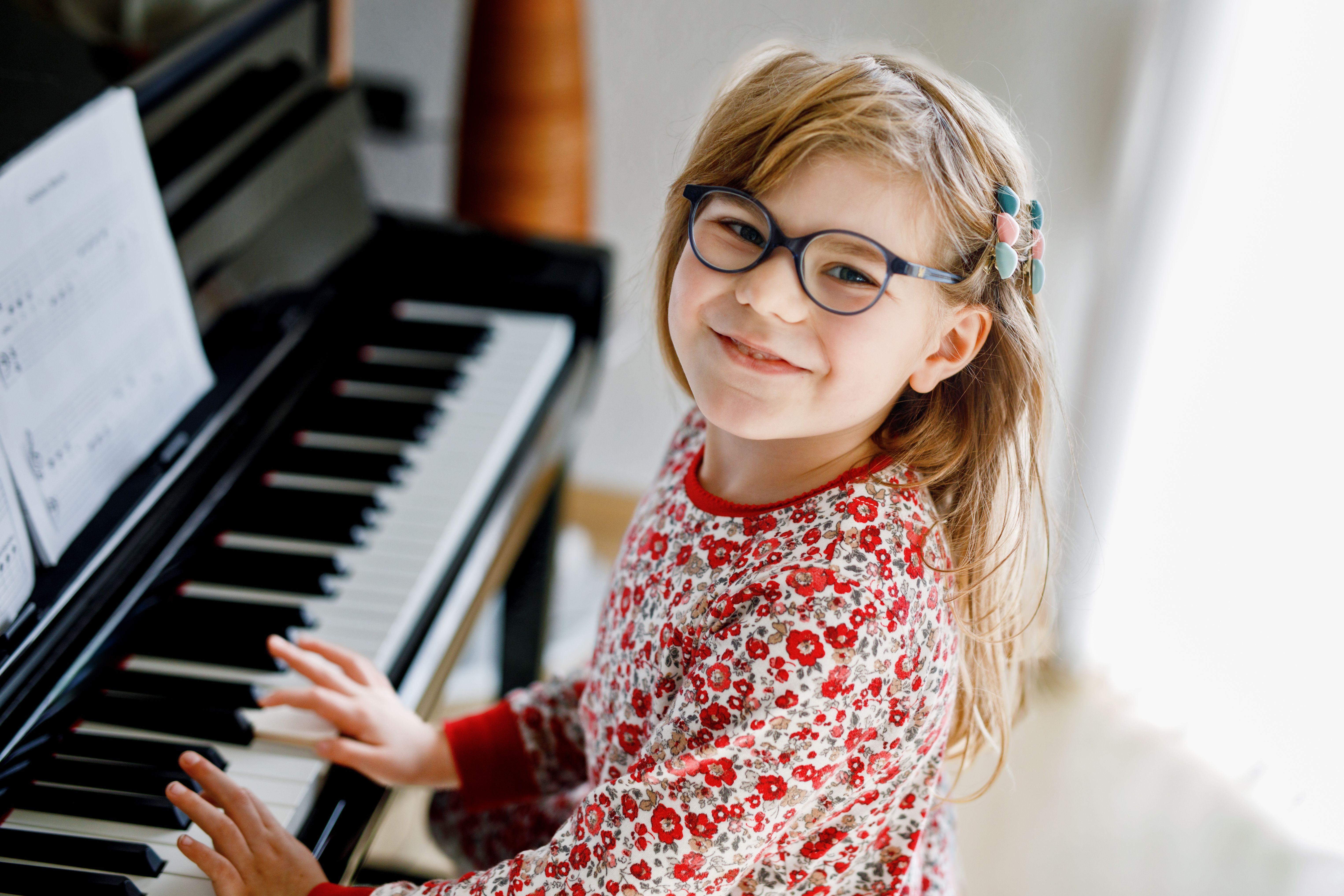 child practicing piano