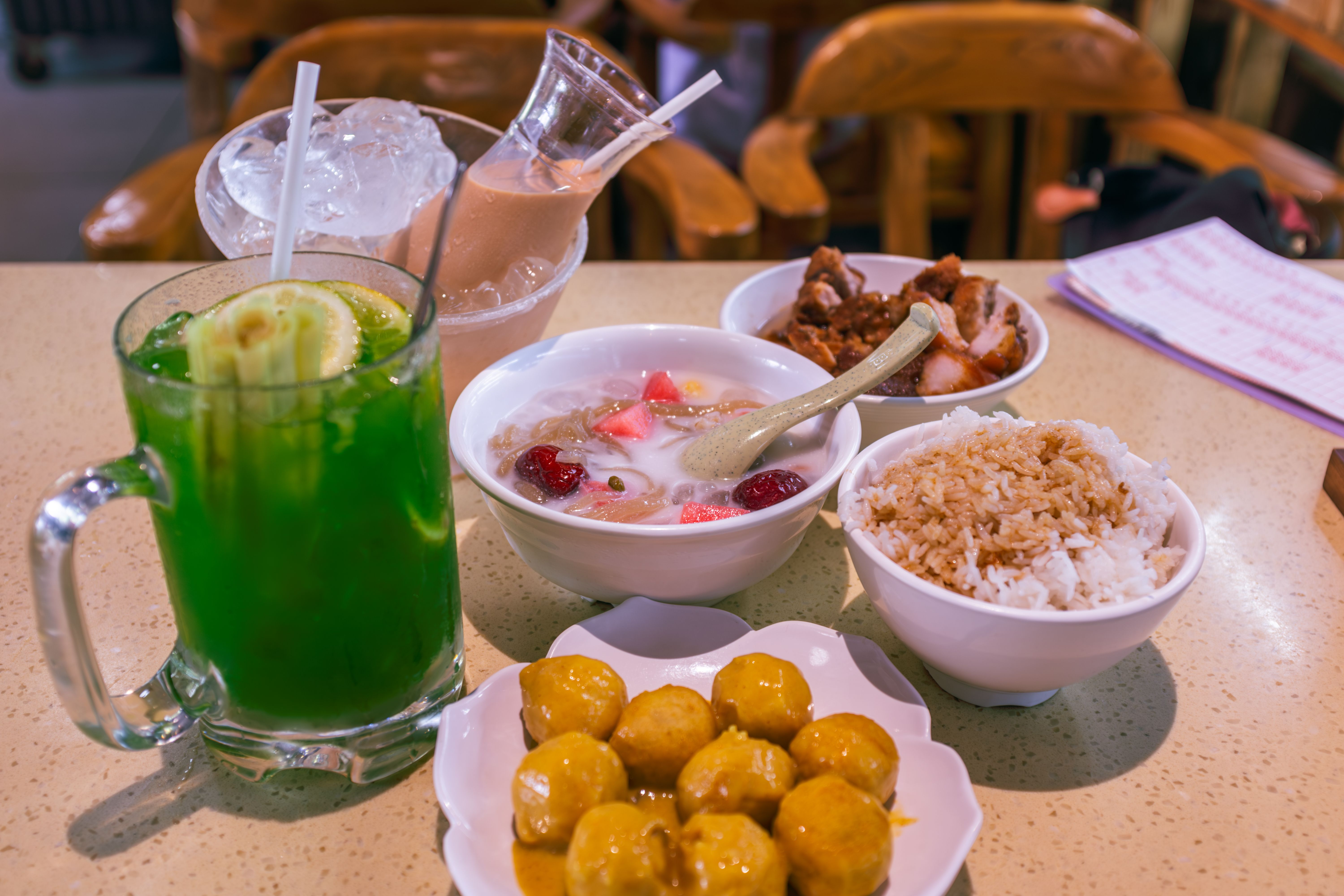 A delicious spread of Southeast Asian street food and drinks.