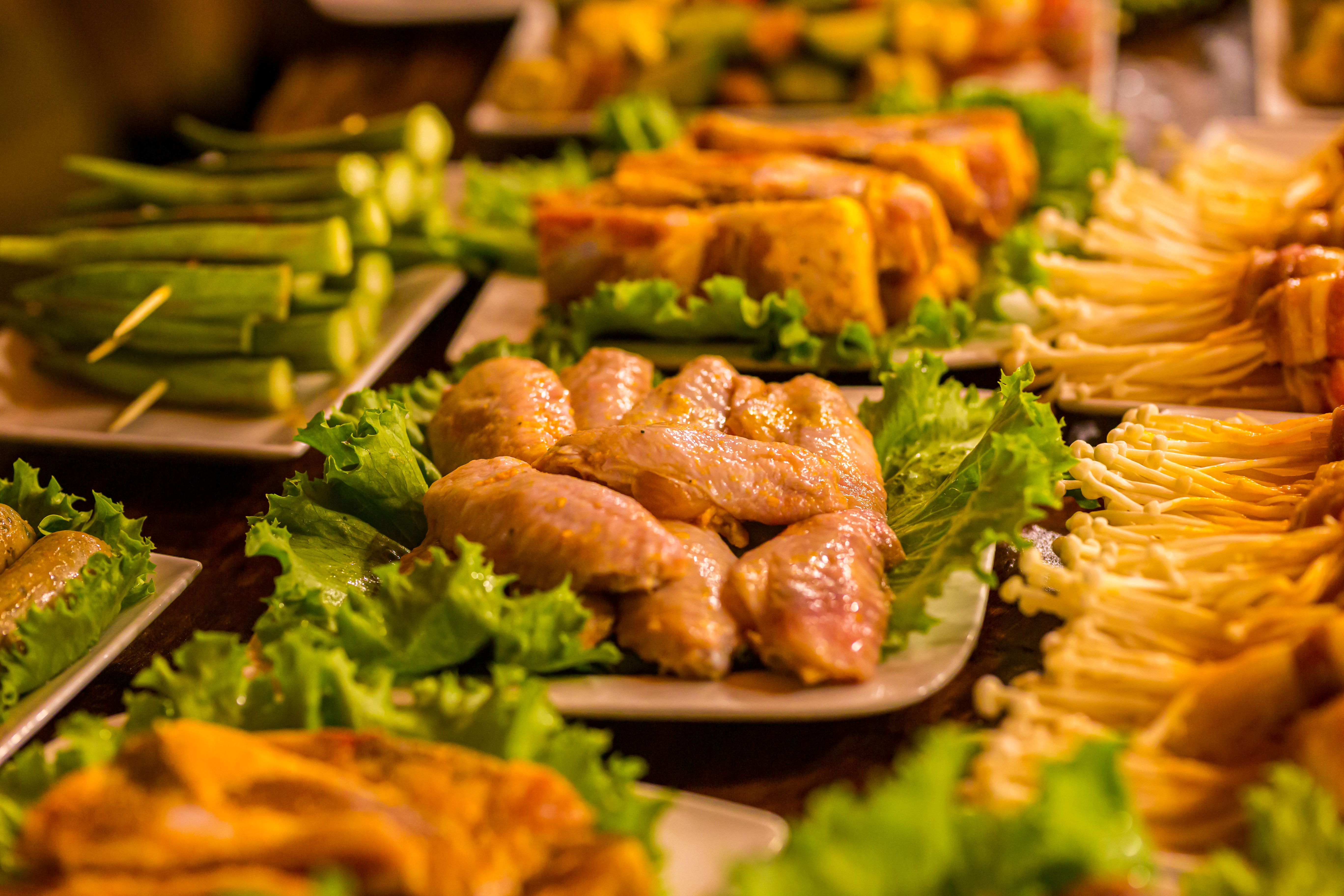 A table full of food prepared for a BBQ party