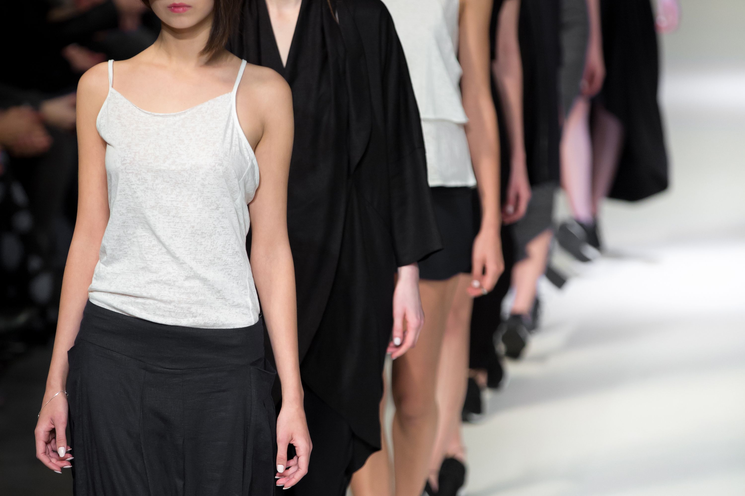 Midsection Of Women Doing Catwalk On Stage Midsection Of Women Doing Catwalk On Stage