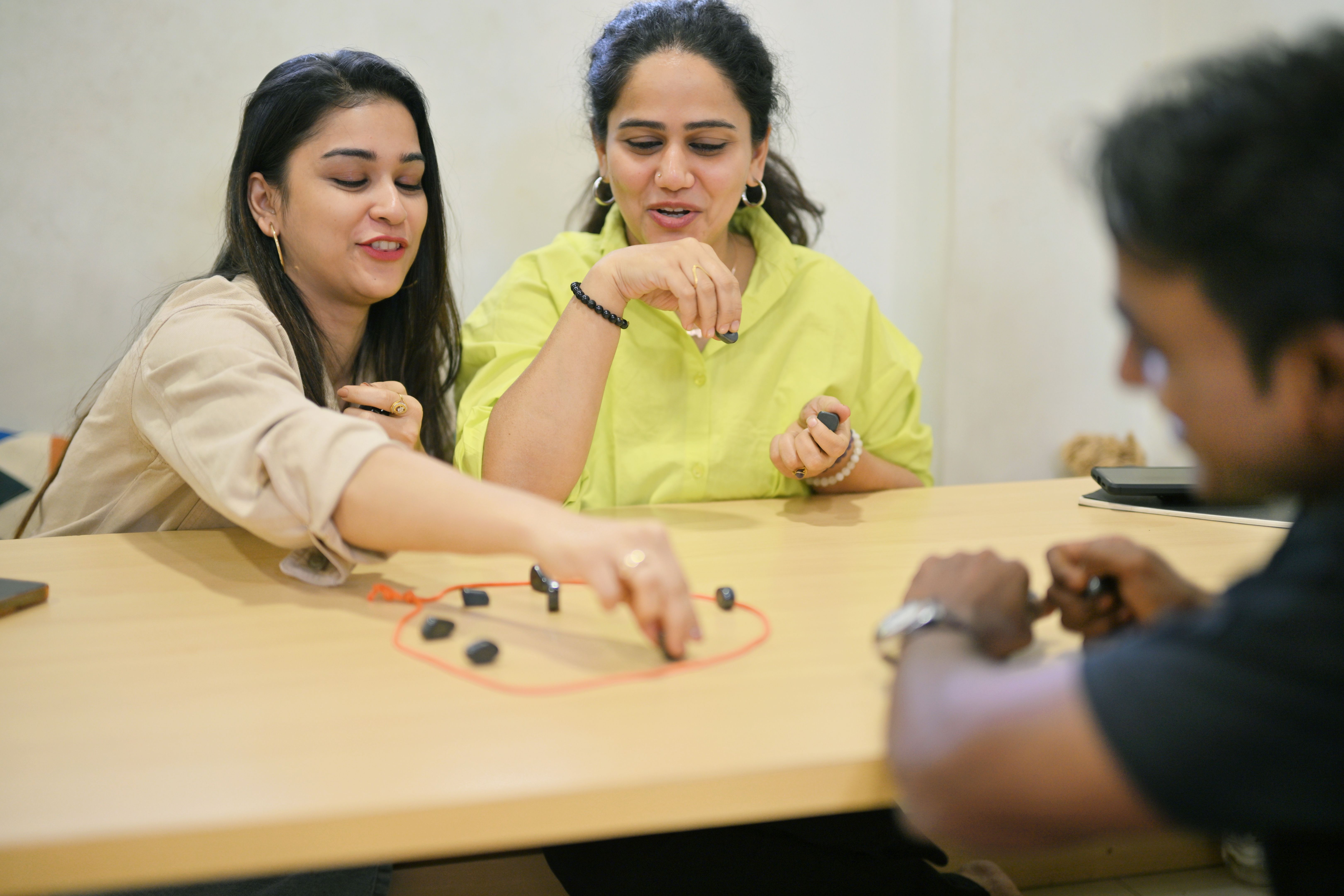 Group of friends having fun playing a game with magnets and rope