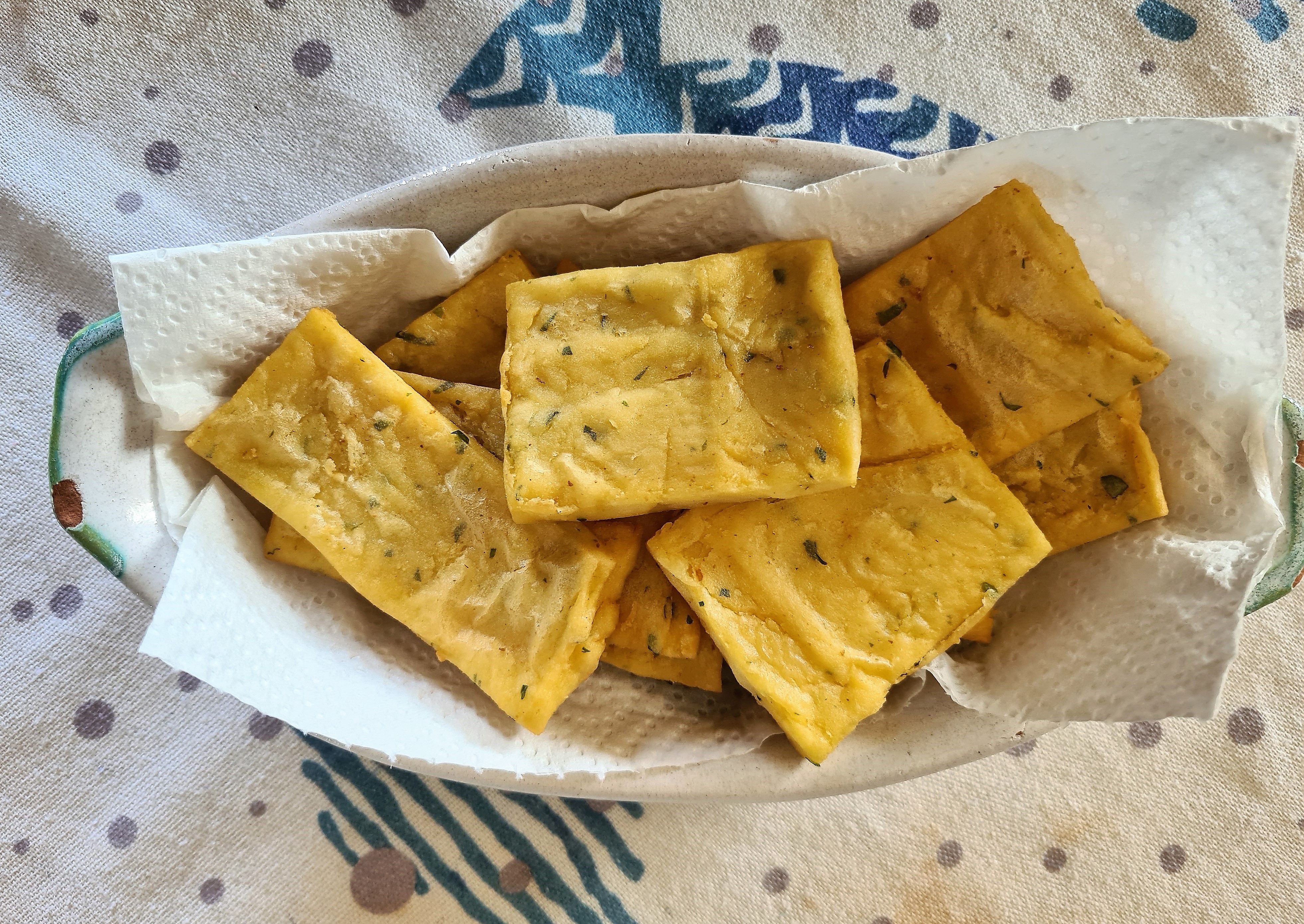 close-up of pancakes made from chickpea flour and parsley
of the typical Sicilian street food 