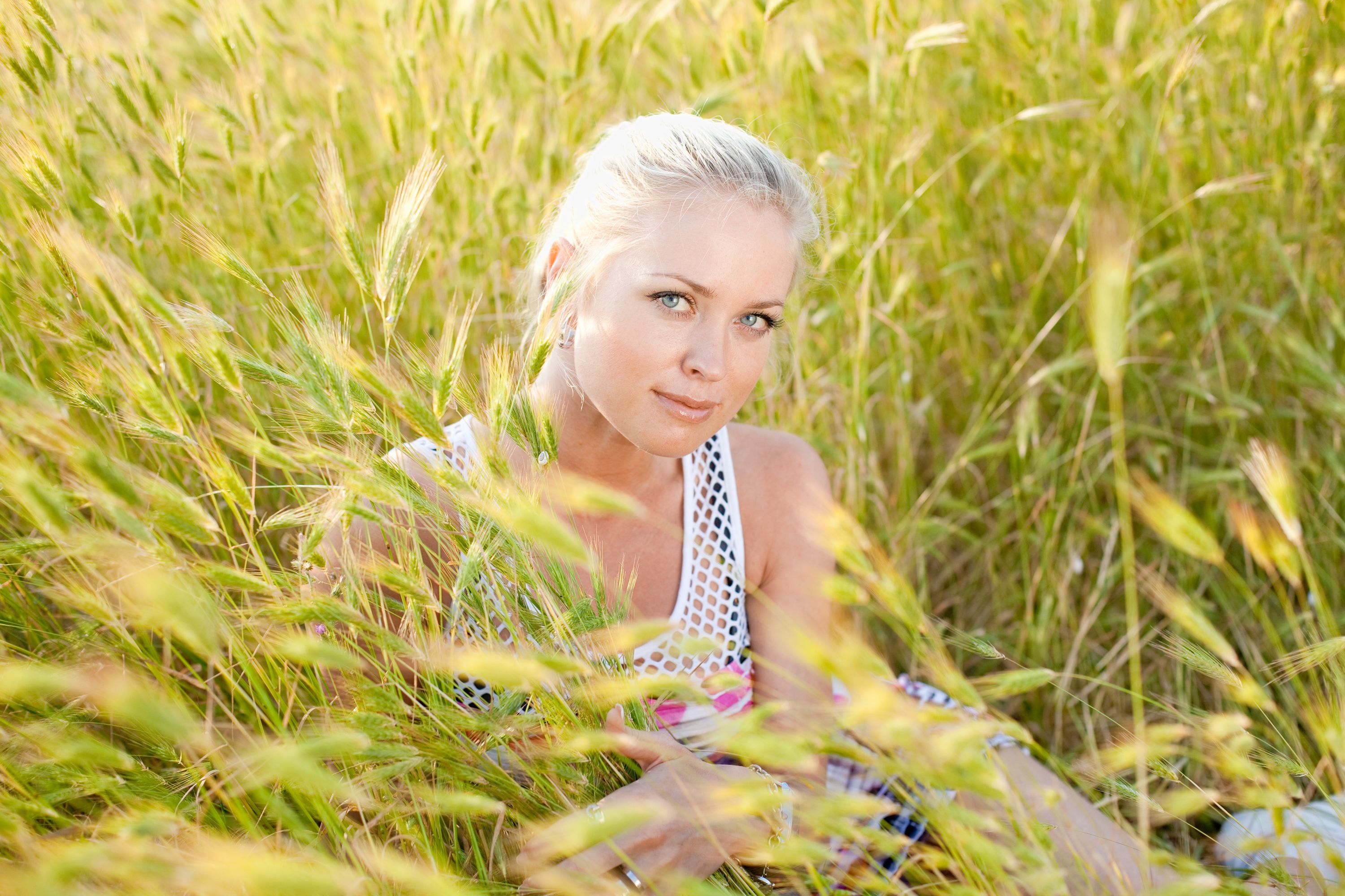 Blonde girl in wild grasses
