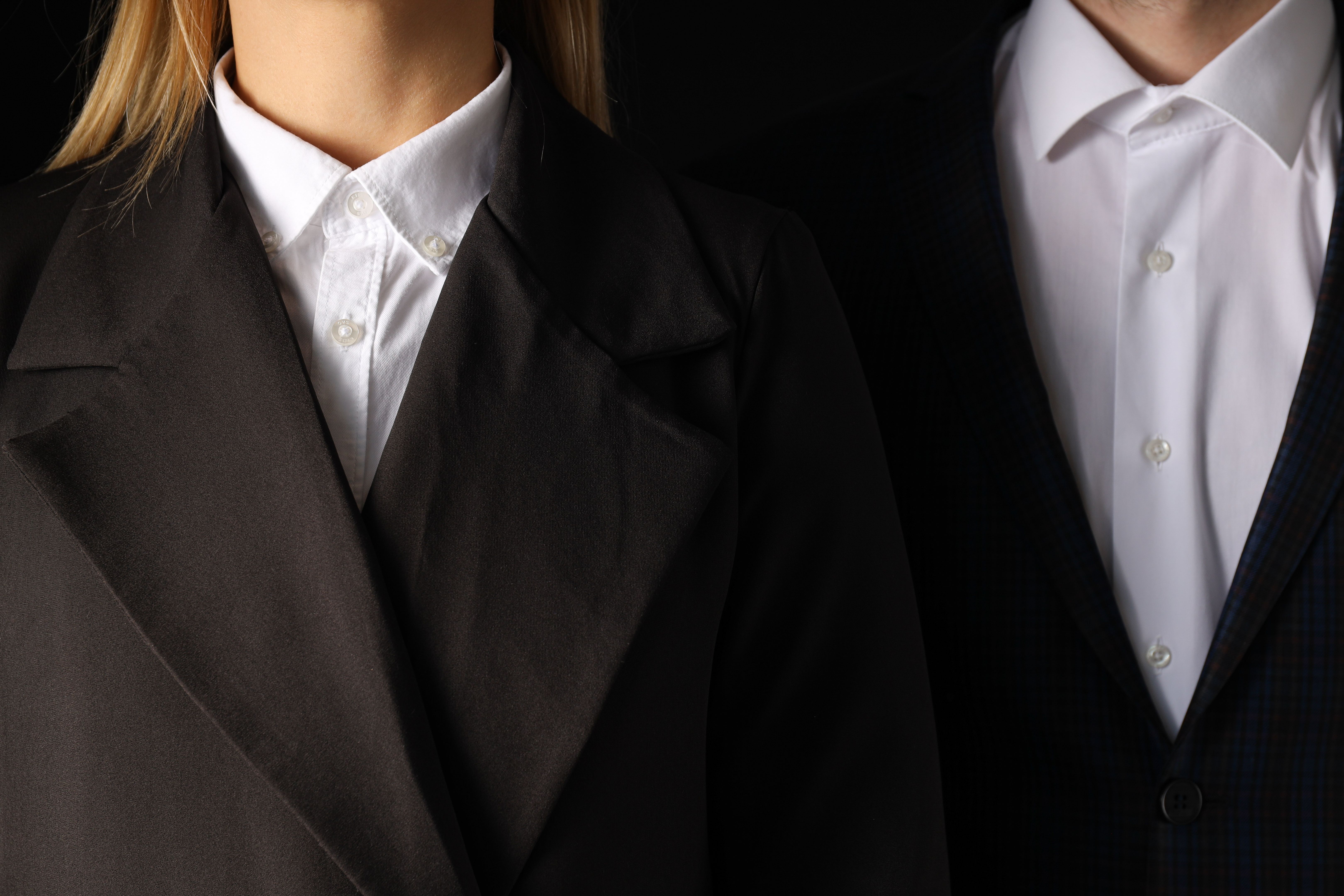 A man and a woman in a black suit on a black background A man and a woman in a black suit on a black background