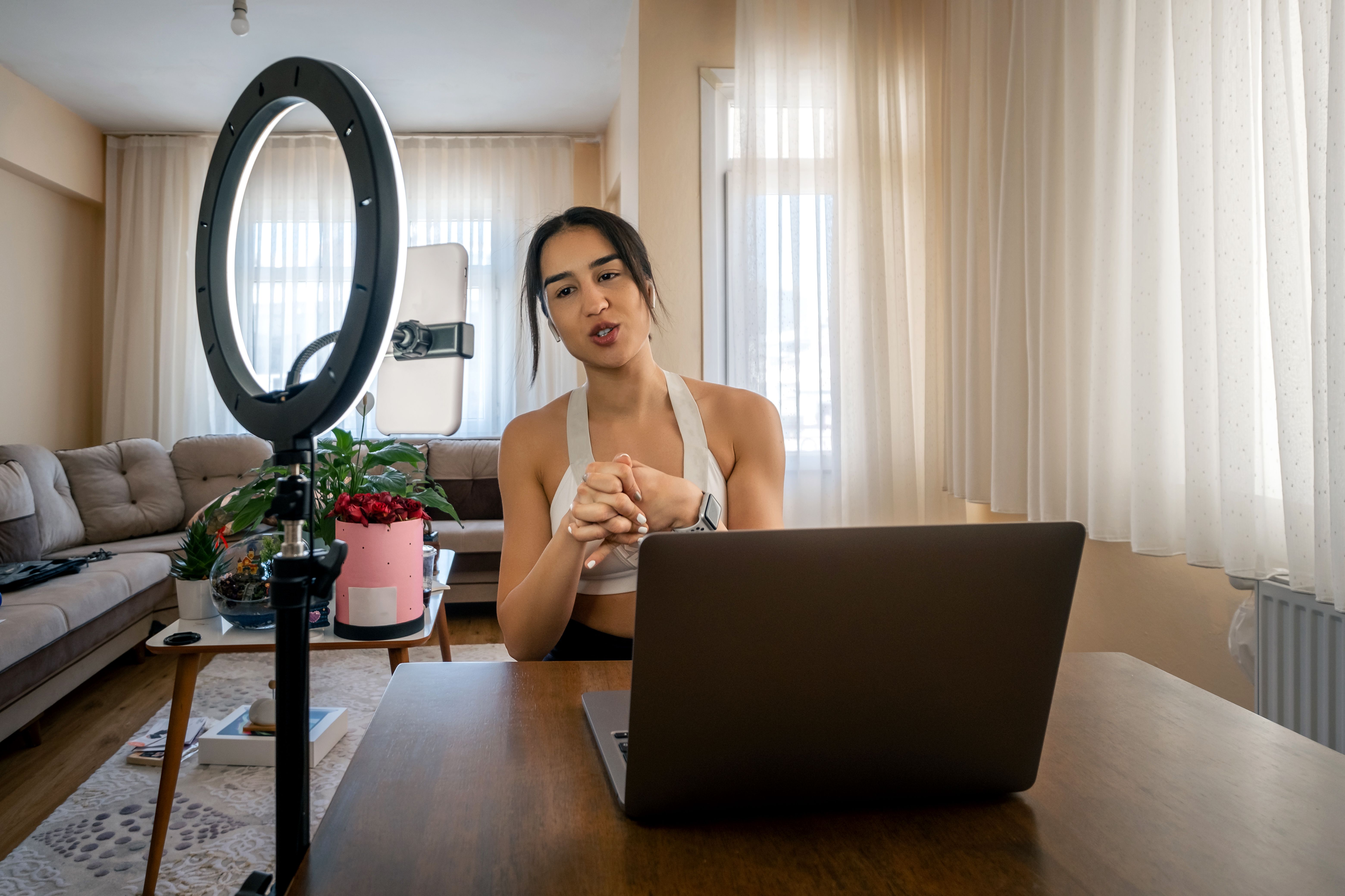 Young vlogger woman broadcasts live at home.