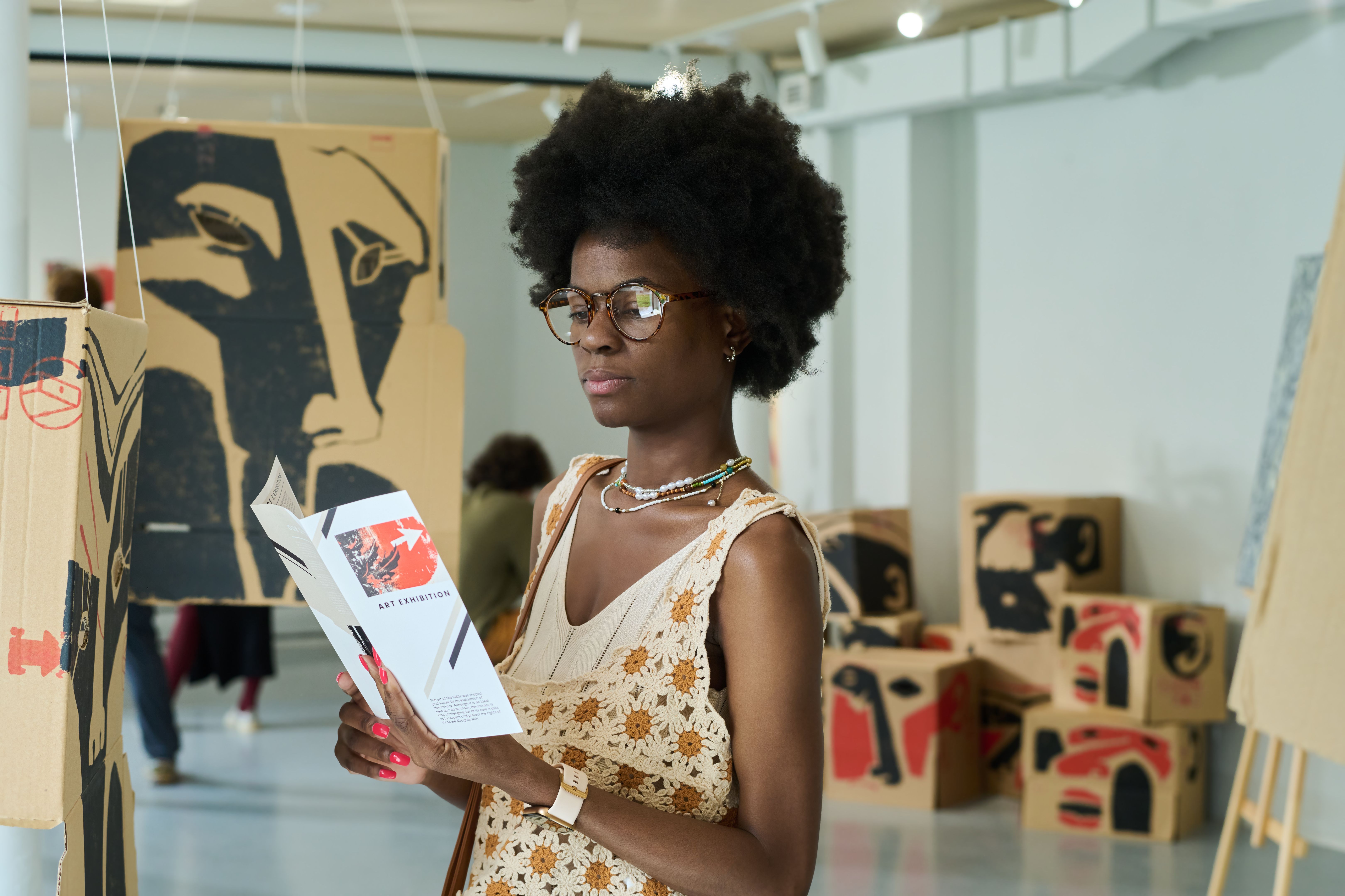 Looking through exhibition brochure Looking through exhibition brochure