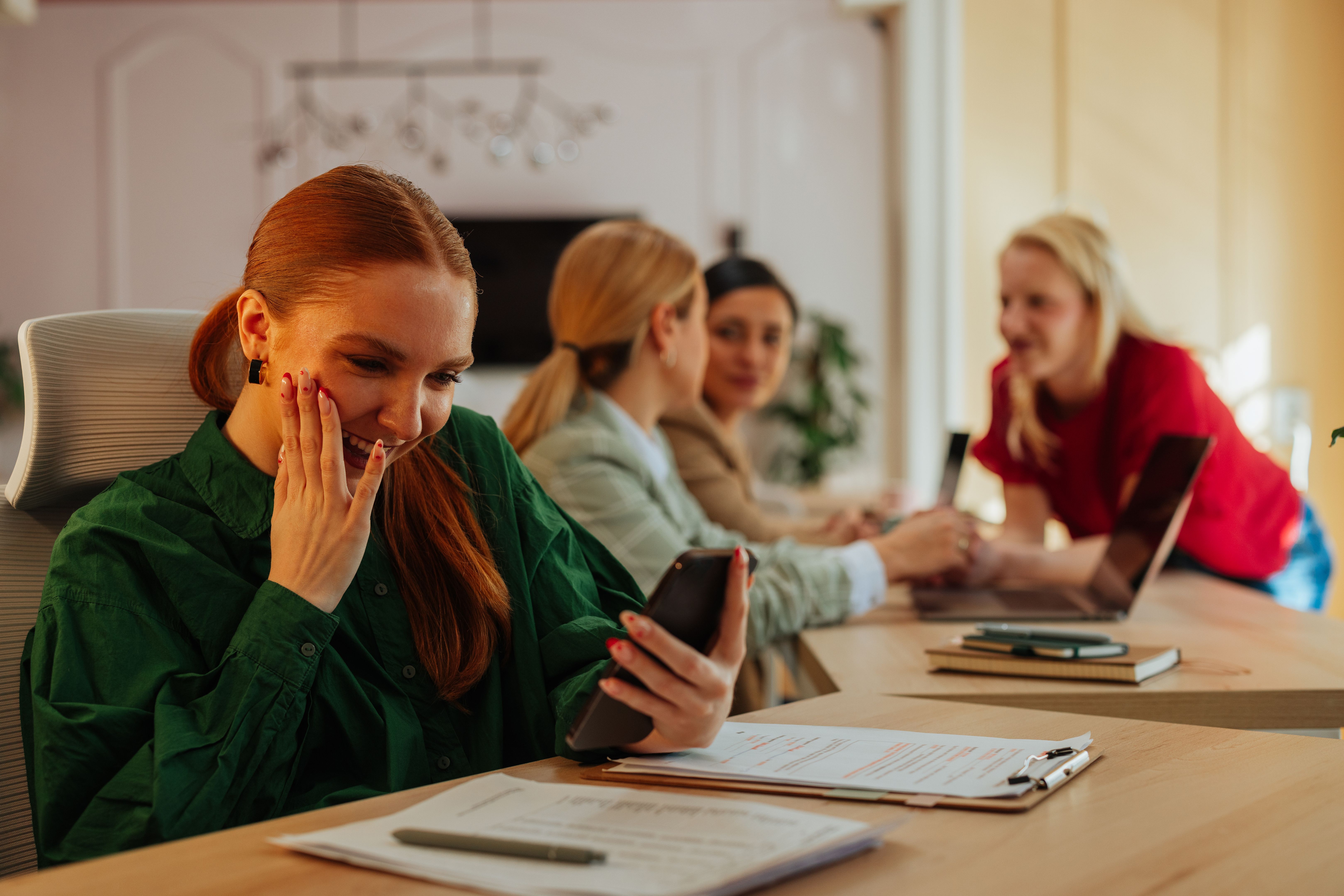 Female worker feeling excited while having a video call in the office Female worker feeling excited while having a video call in the office