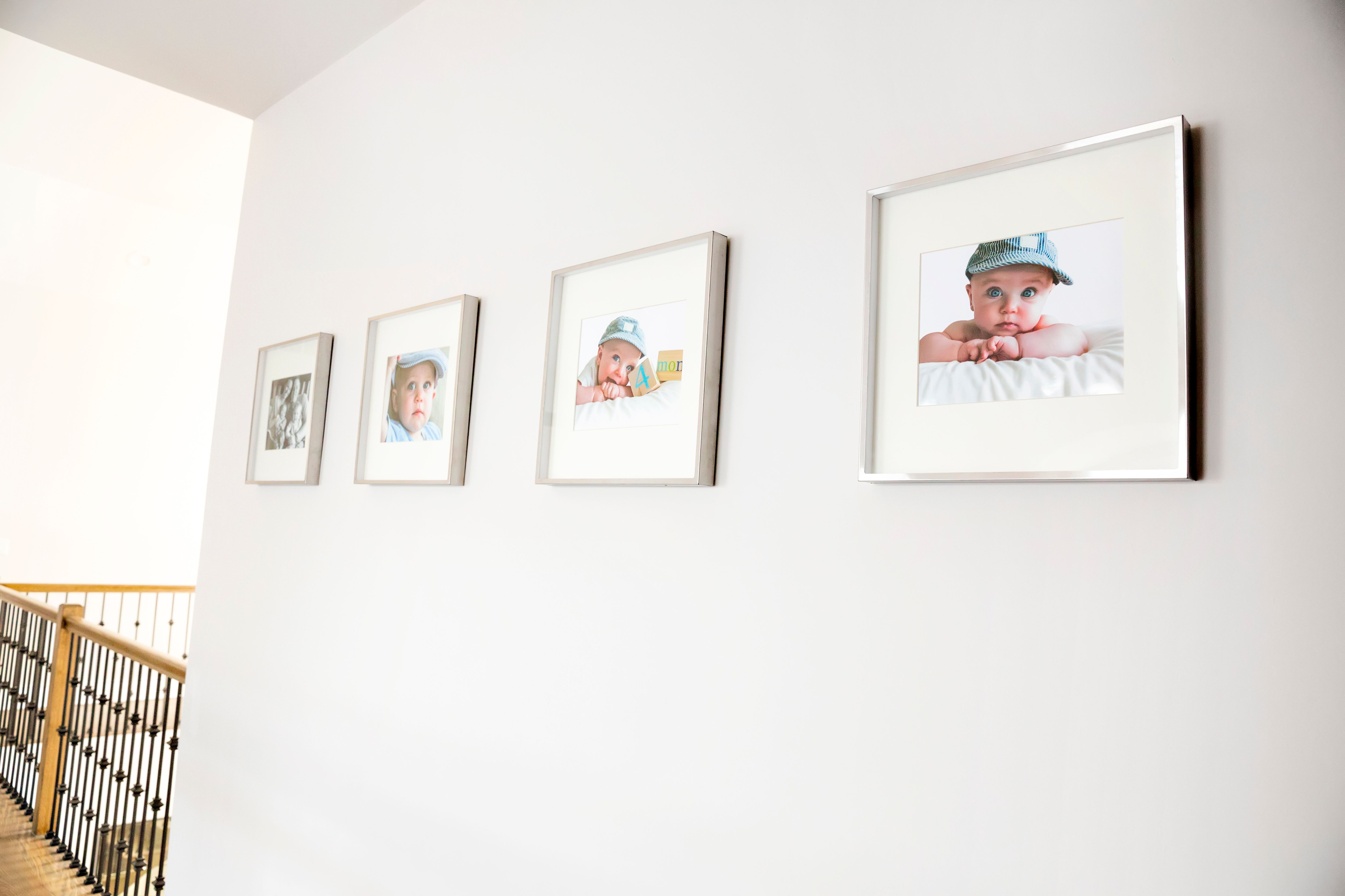 Family portraits hanging on a wall in a home rm Family portraits hanging on a wall in a home rm