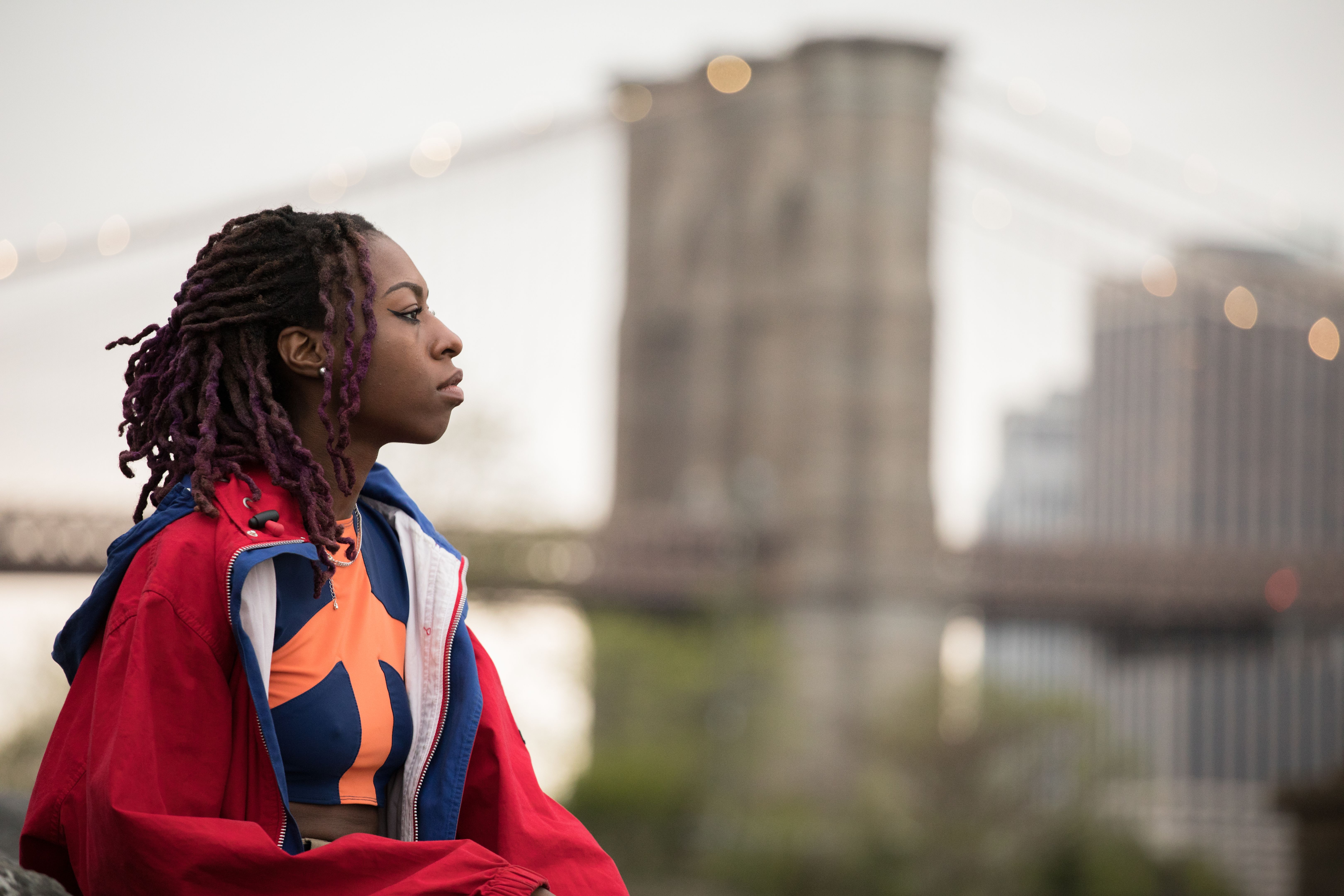 A female African American Teenager looks at the NYC skyline