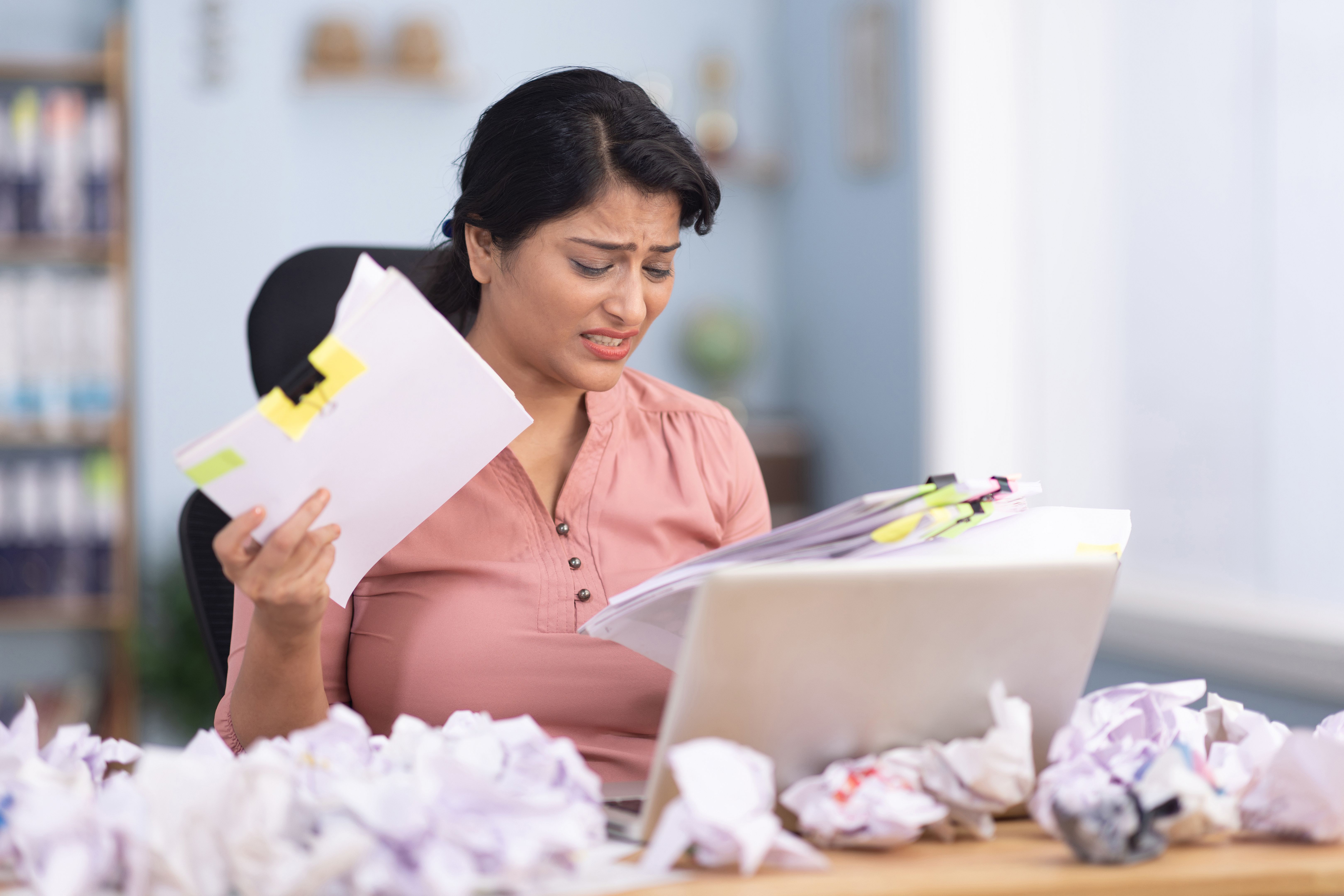 Businesswoman using laptop frustration overworked in office stock photo Businesswoman using laptop frustration overworked in office stock photo