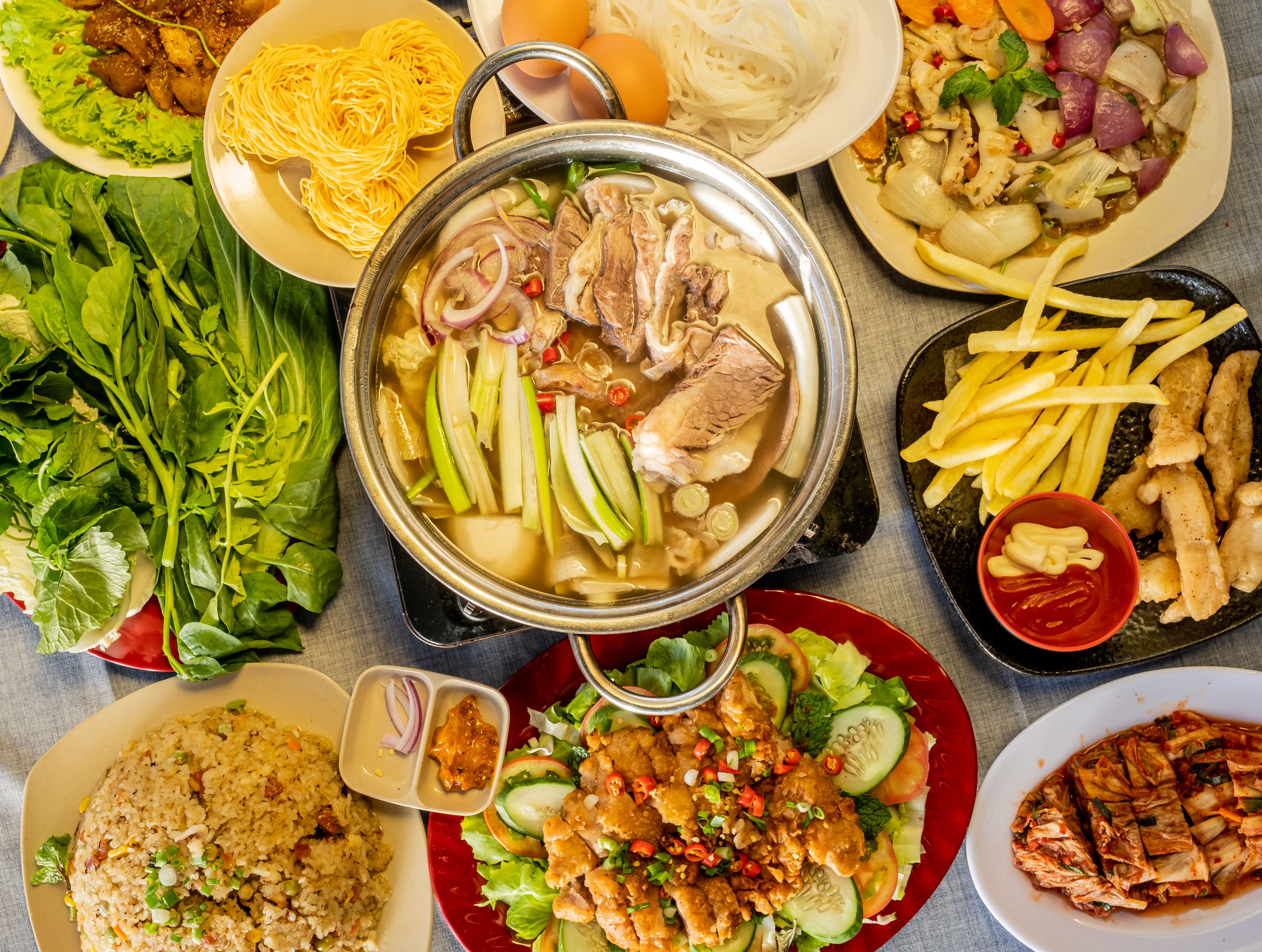 Delicious traditional dishes of food, meat, salads and vegetable for Asian family