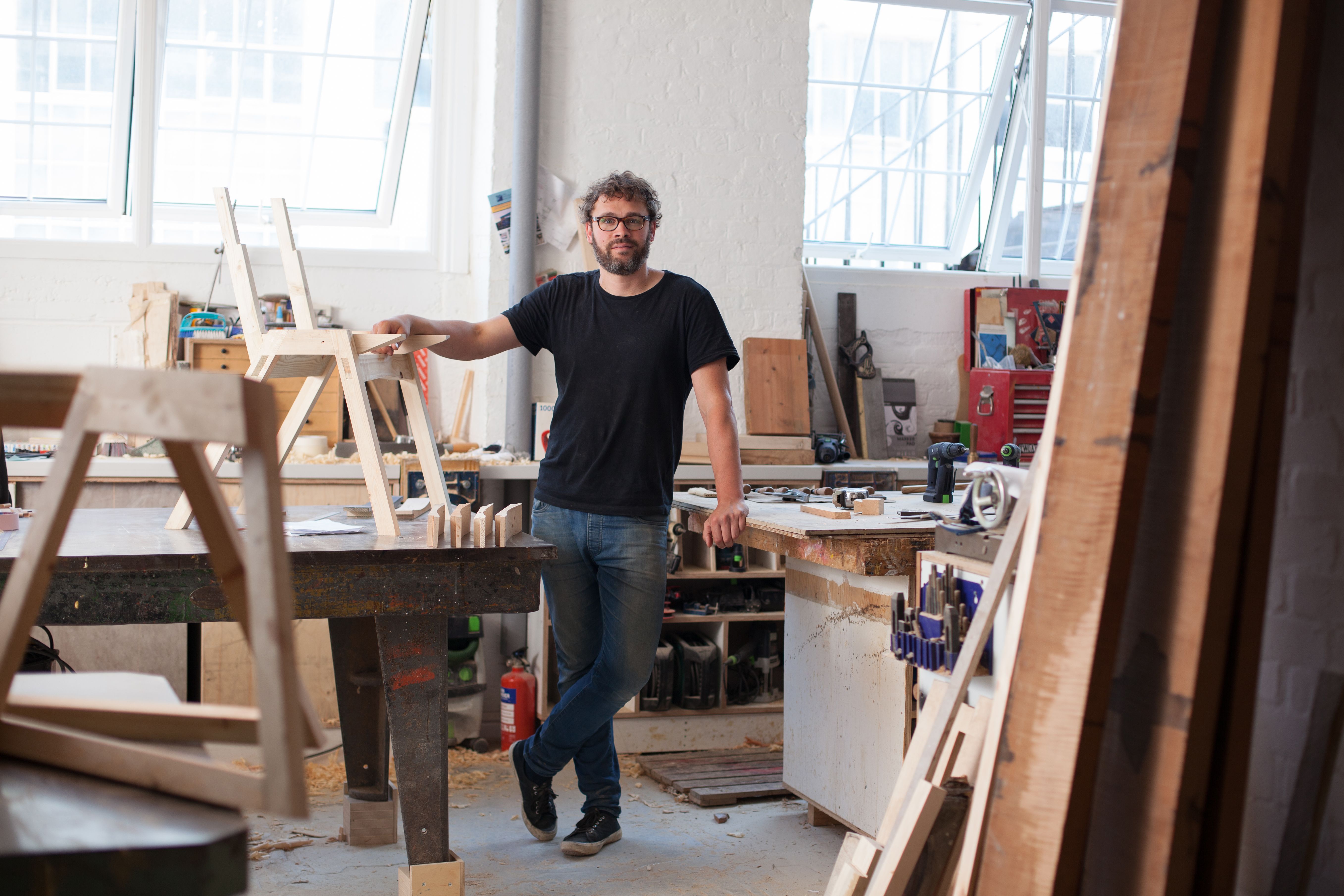 Environmental portrait of a furniture designer maker in his workshop