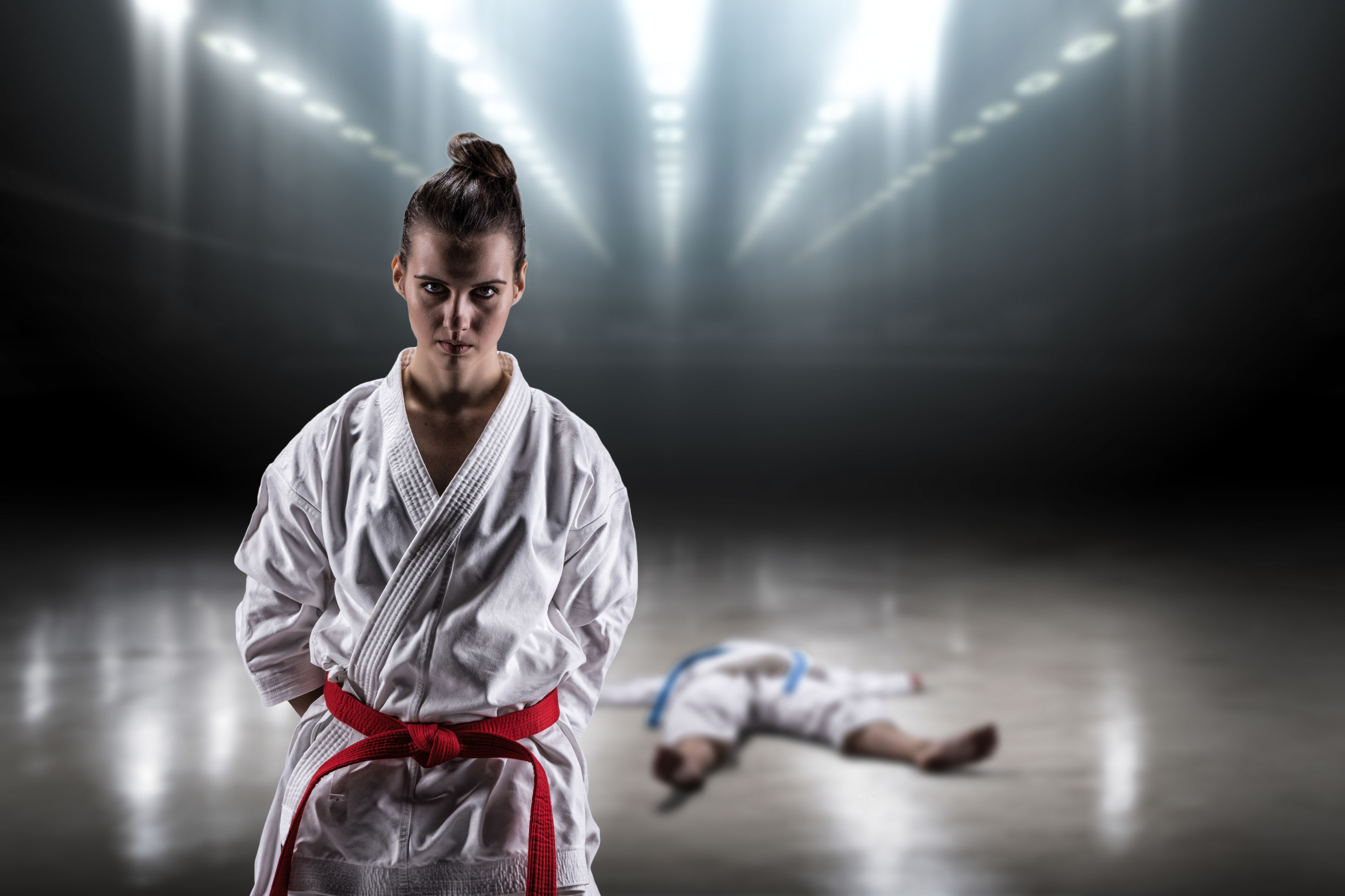 Sexy girl in a kimono karate rejoices victory