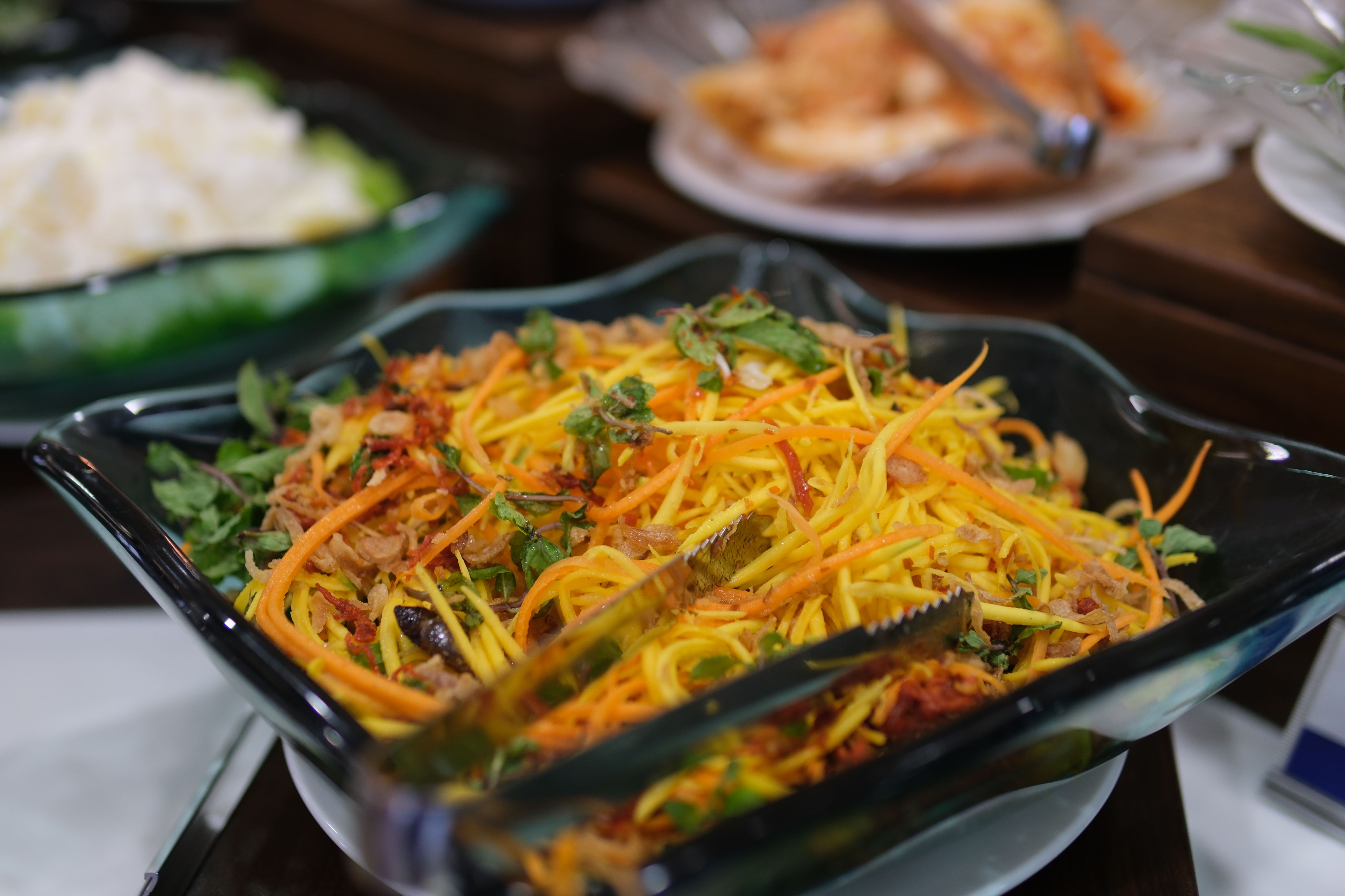 Mix the ingredients to make mango salad.