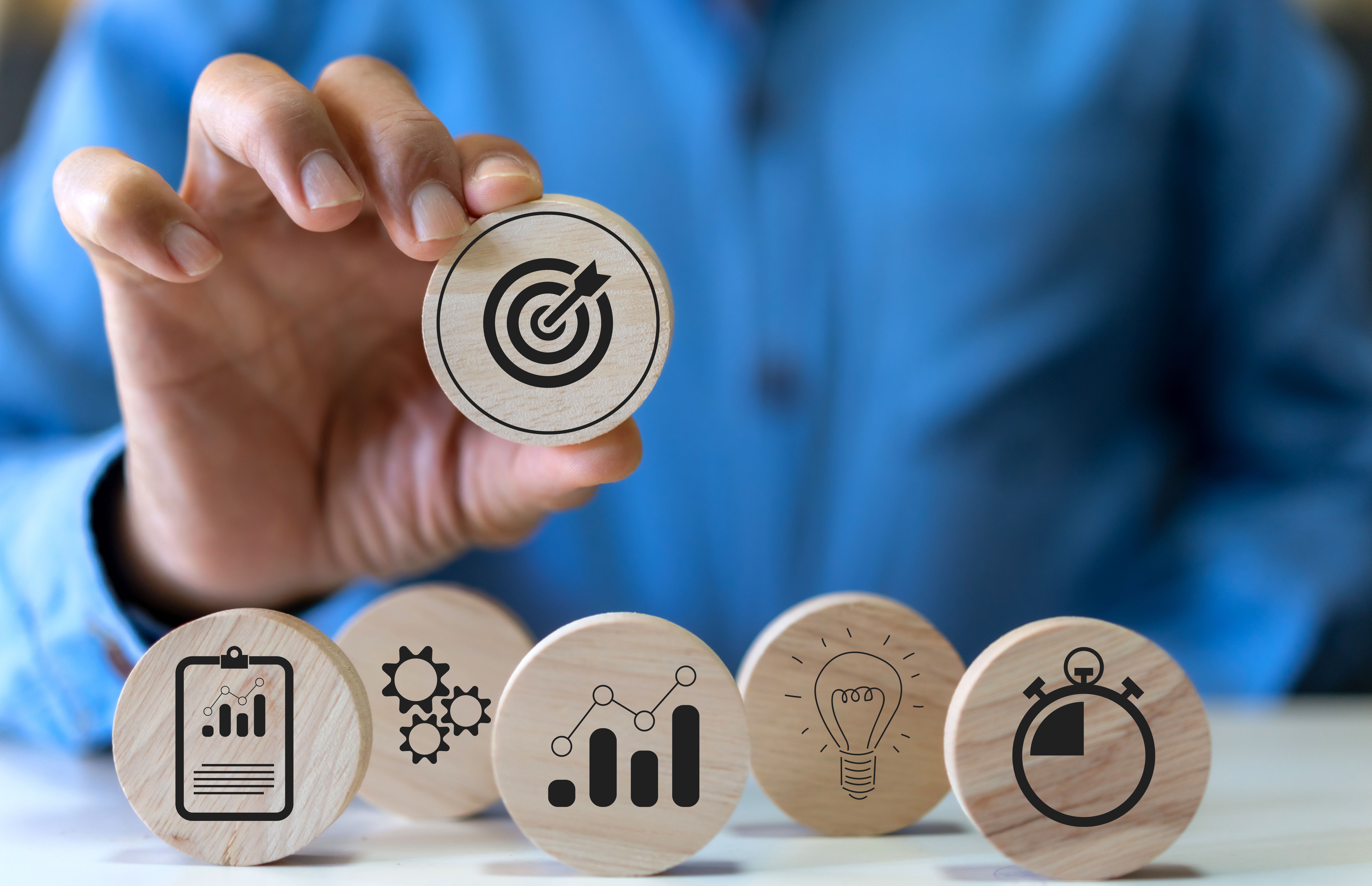 Hand holding wood block choose target icon business, target goal, market goal, consumer, digital marketing, strategy, action plan, achievement, success, financial growing, business development