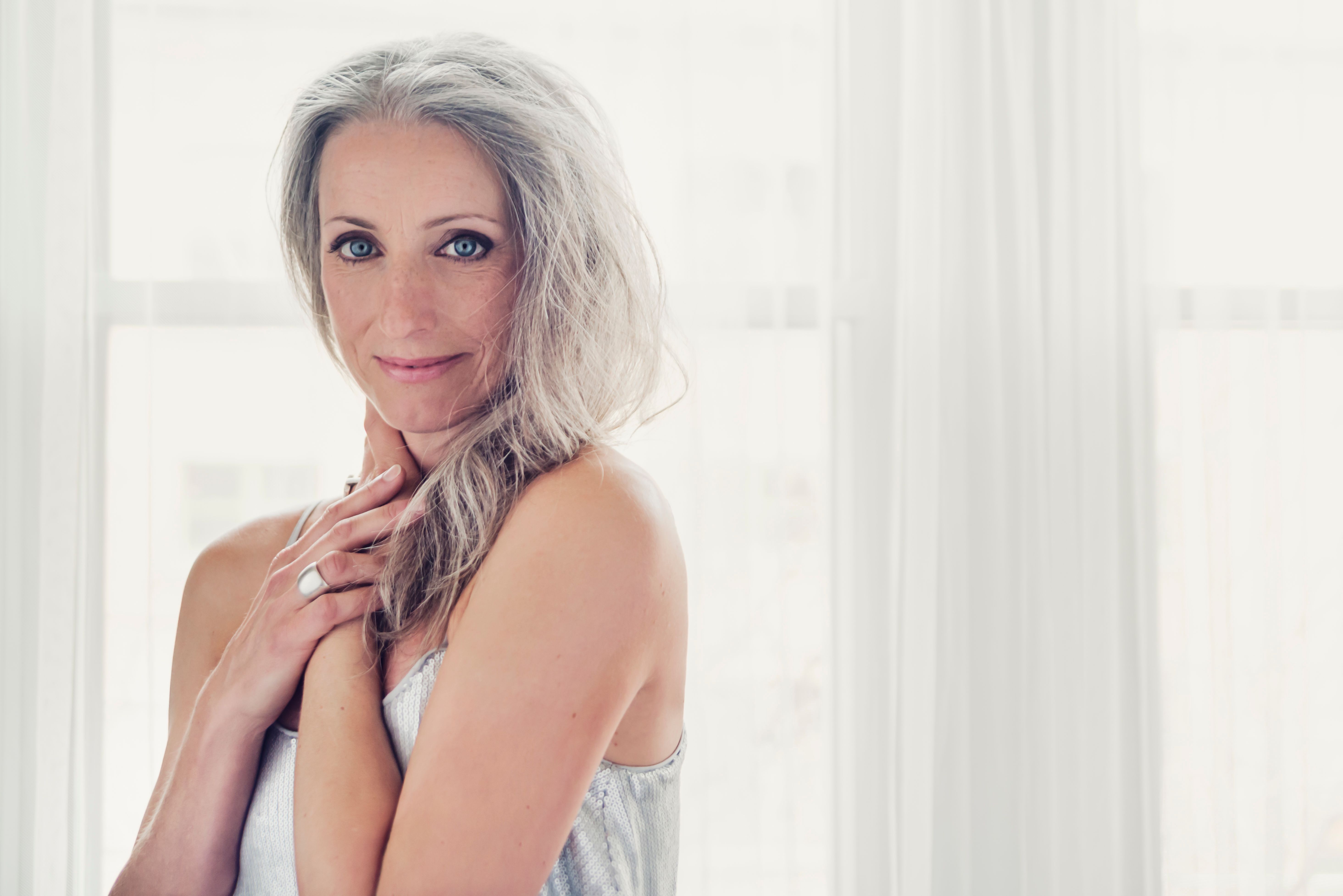 Aging gracefully, beautiful mature woman with silver hair and dress.