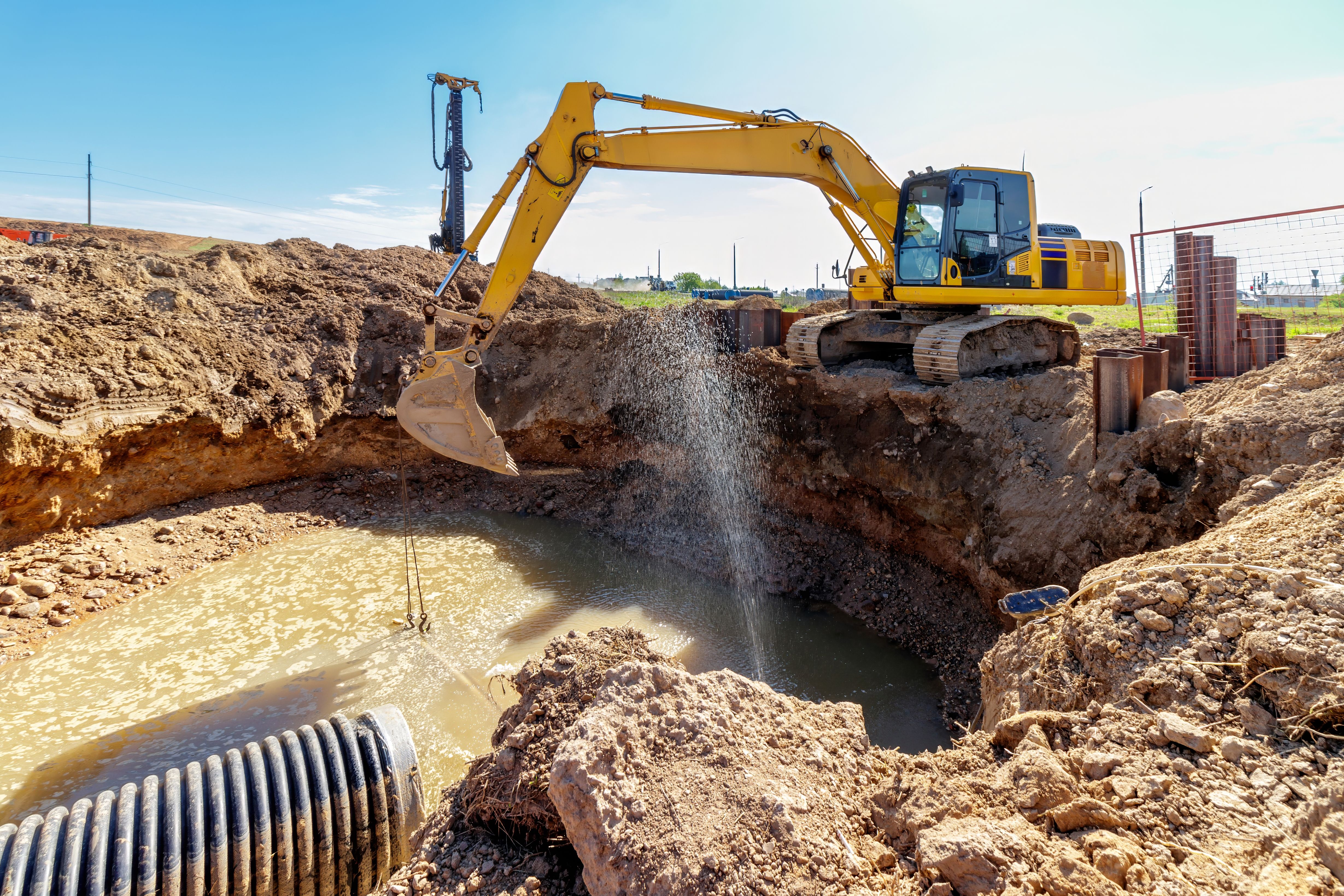 Excavator at a Construction Site Digging a Large Trench