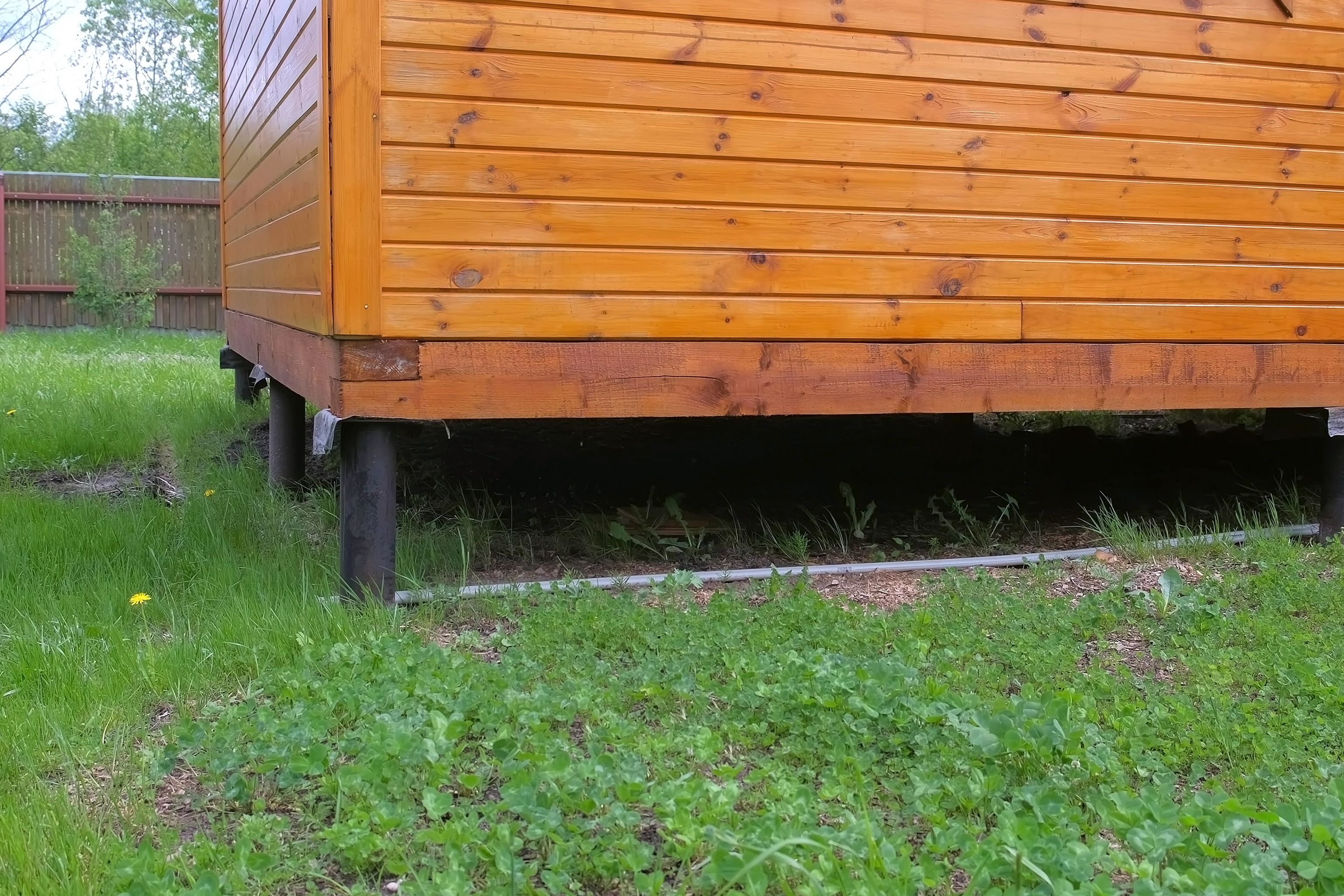 Wooden house on stilts on farm homestead, stilts closeup. Wooden house on stilts on farm homestead, stilts closeup.