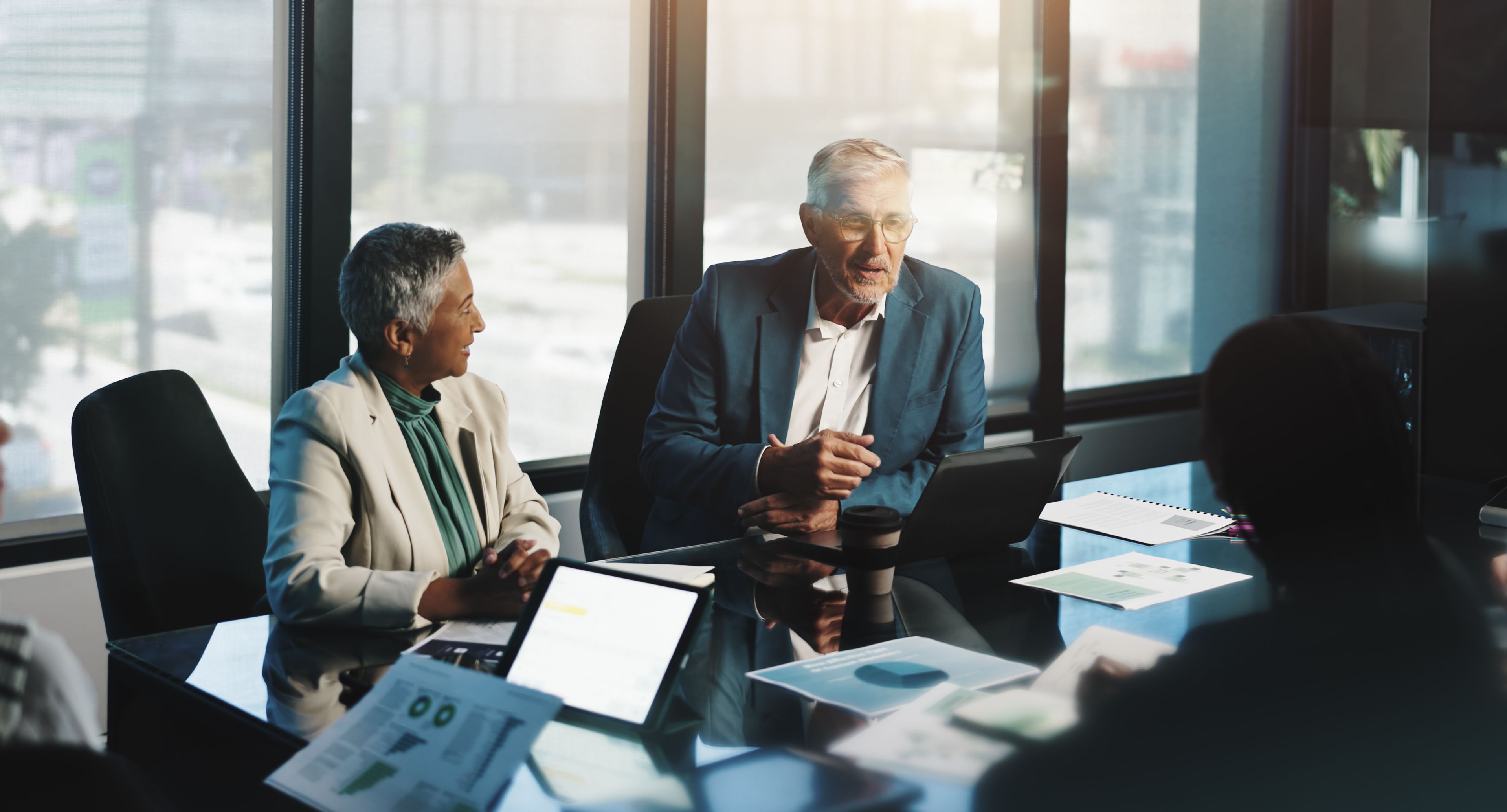Nonprofit board members discussing accurate record-keeping, governance responsibilities, and compliance with 501(c)(3) regulations during a meeting.