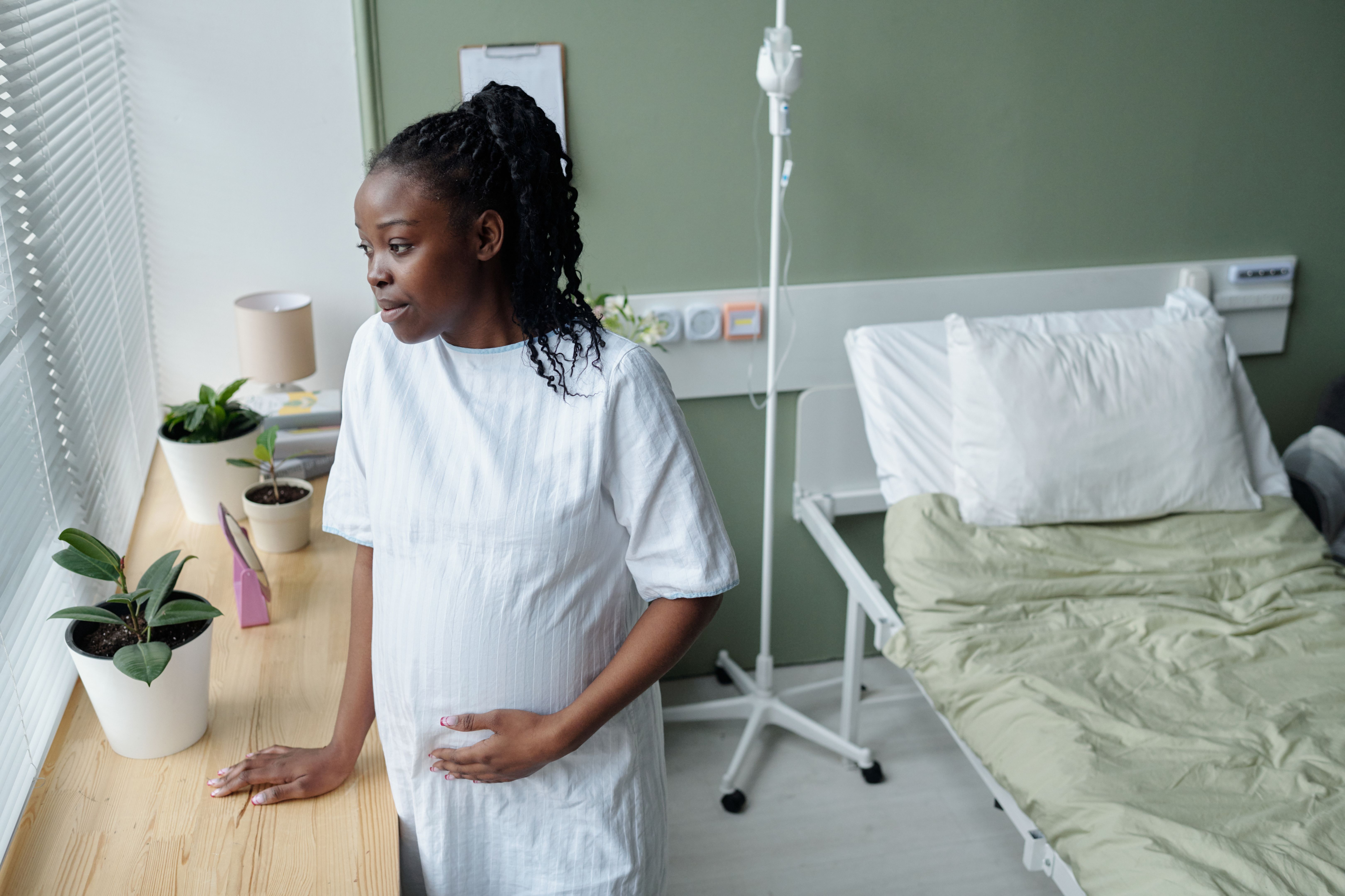 Pregnant mother holding ultrasound with family
