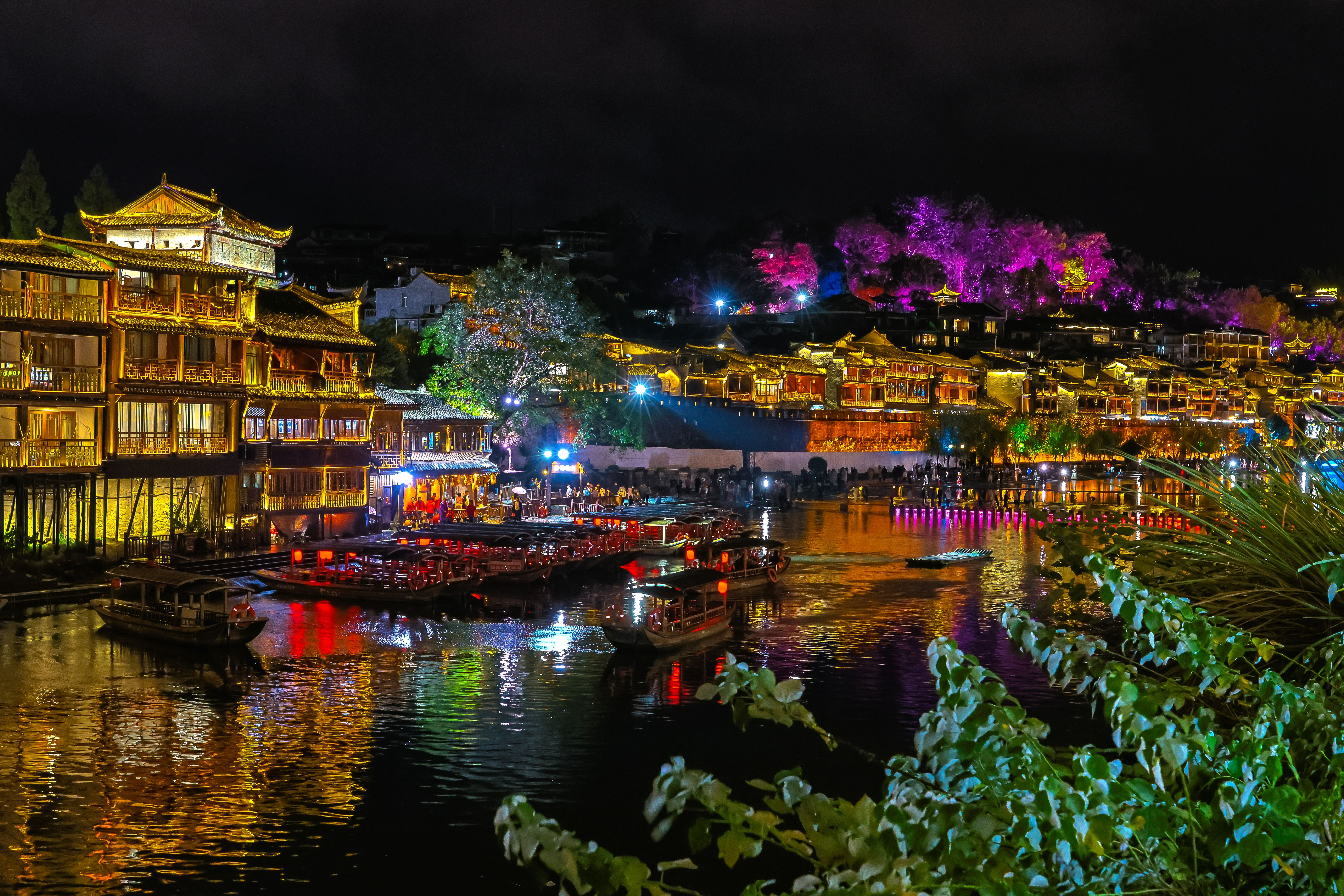Night view of Fenghuang with lantern reflections on the river Night view of Fenghuang with lantern reflections on the river