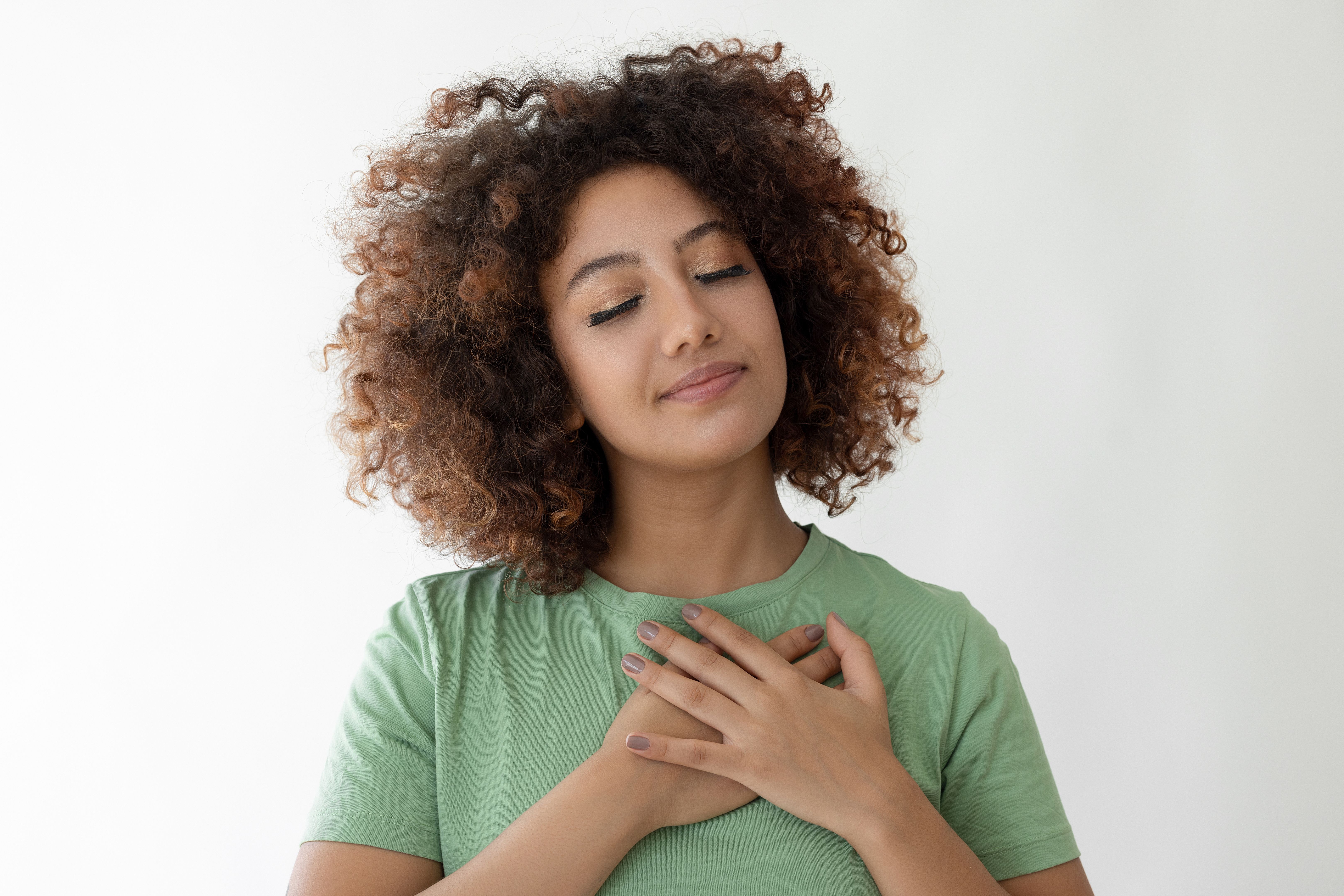 Young woman crossing her hands on her chest Young woman crossing her hands on her chest