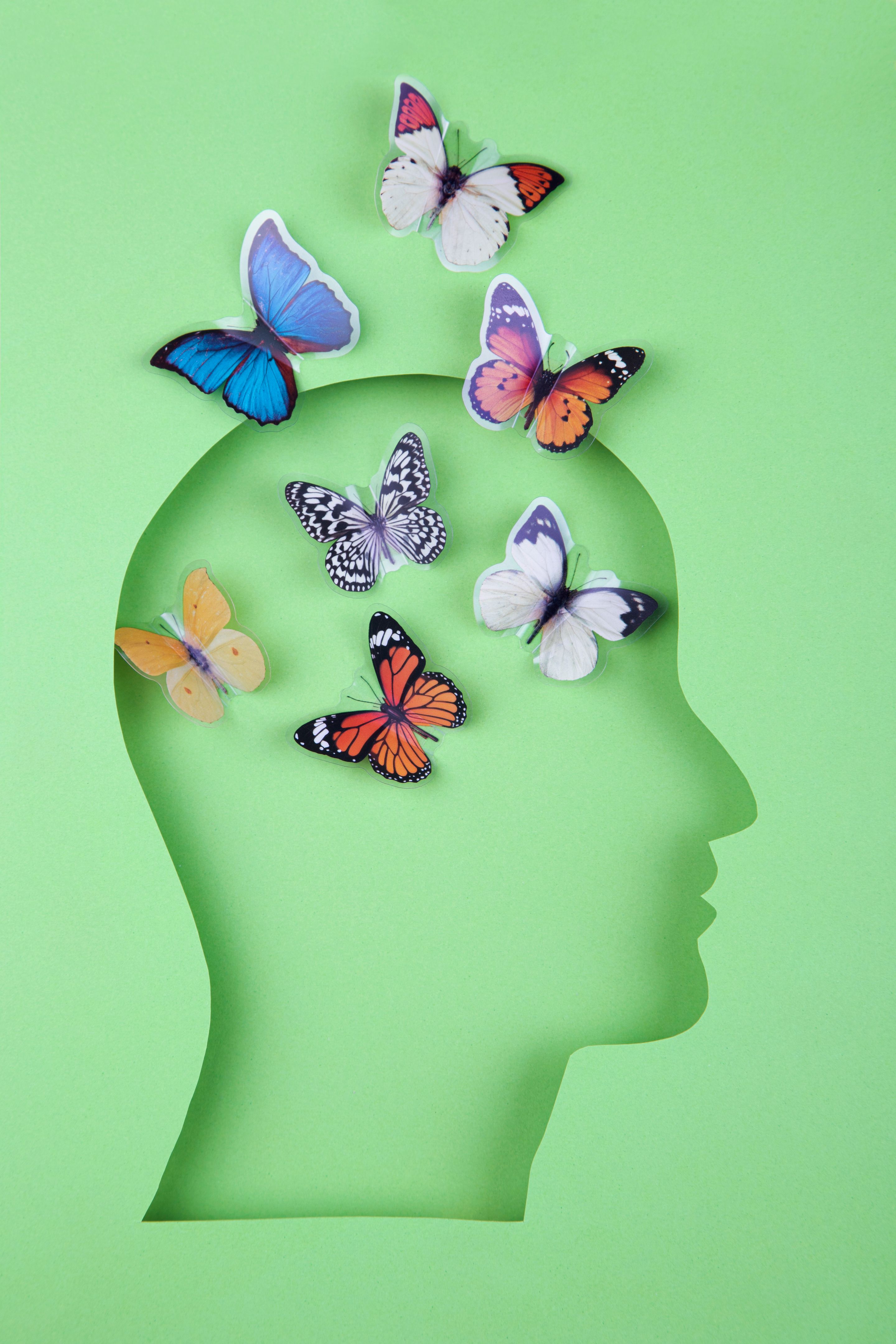 Human head in paper cut style and butterflies