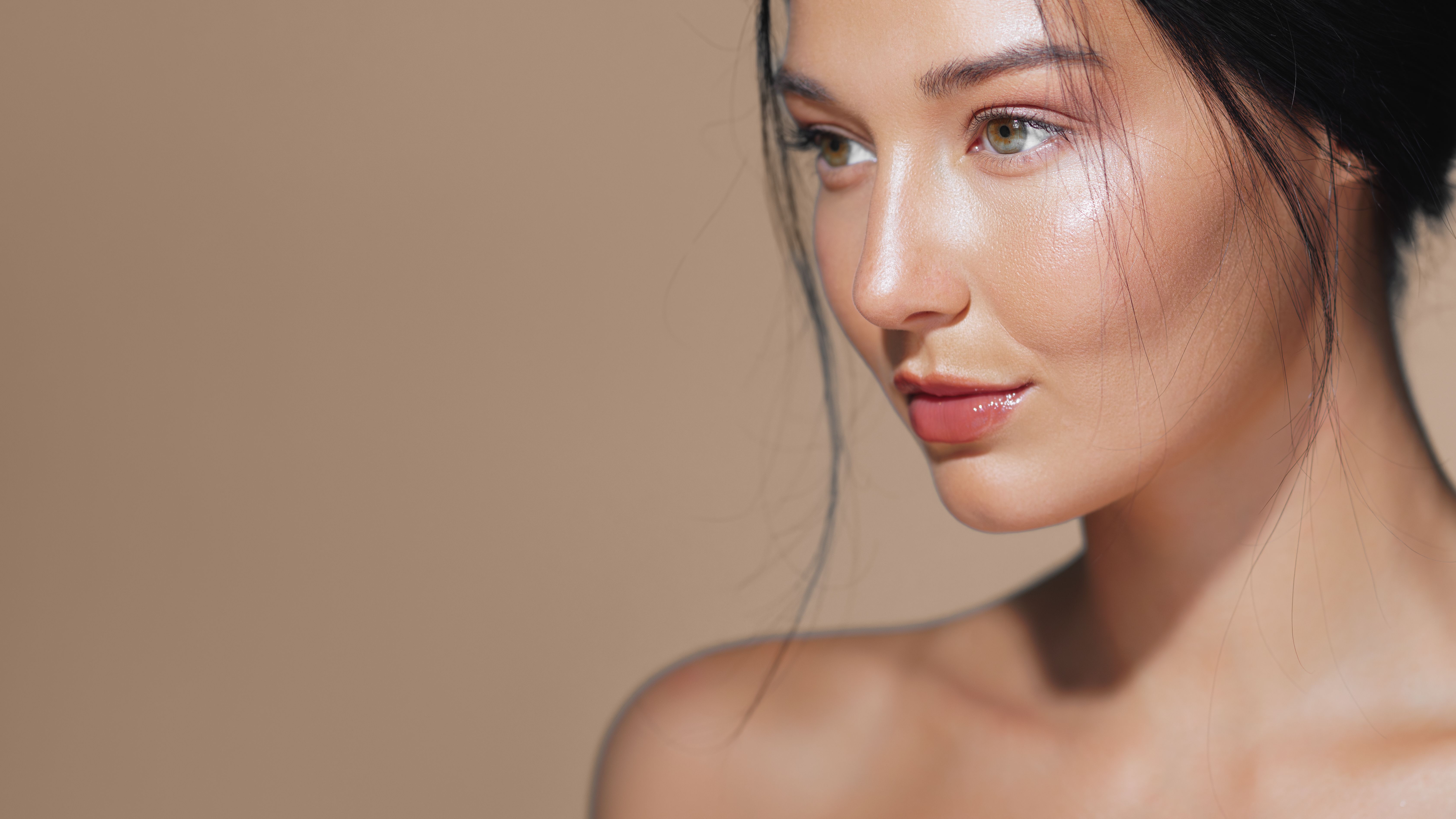 Beautiful Asian Woman with Glowing Skin Posing in Studio