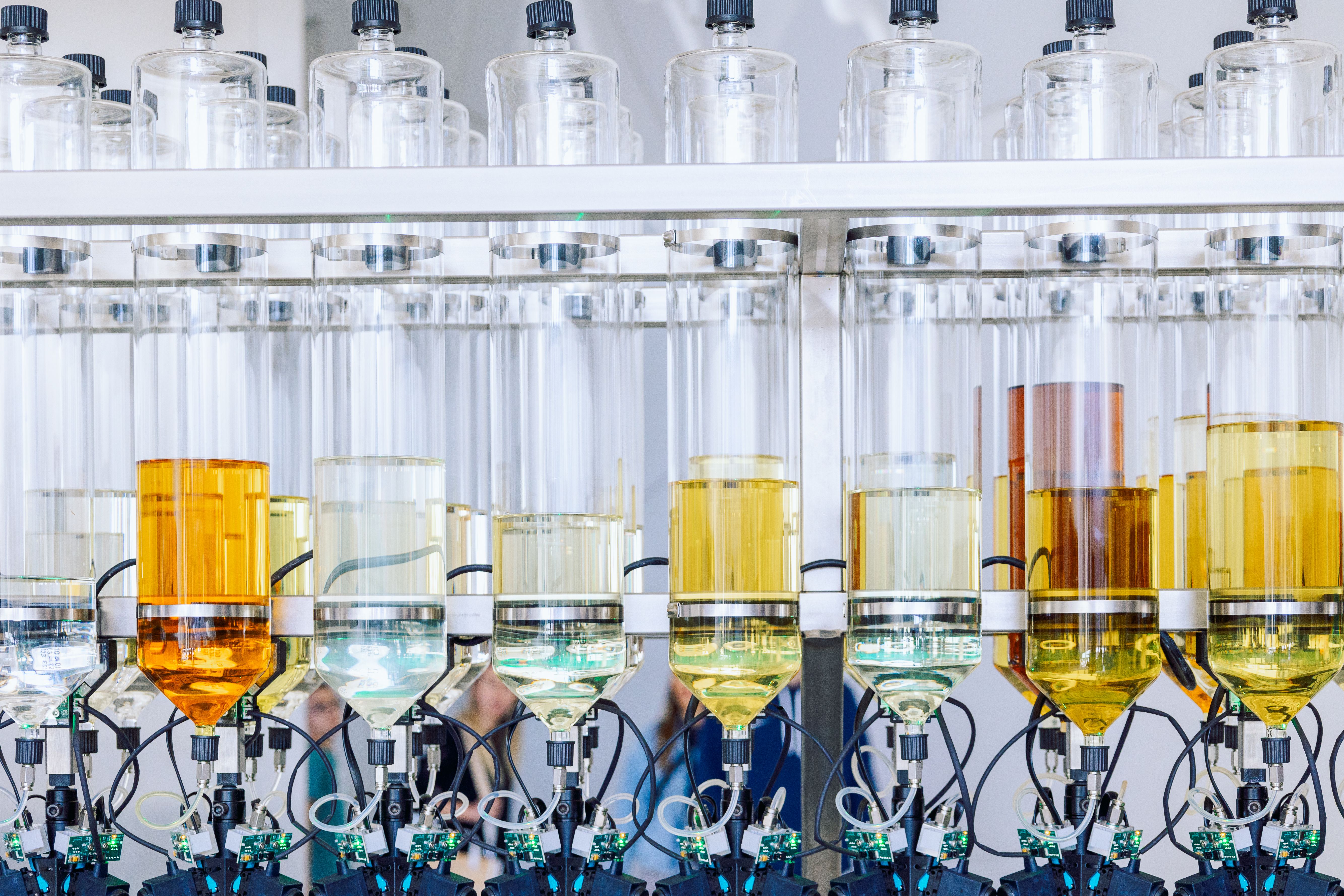 Glass bottles flasks with aroma oils for making perfumes in row Glass bottles flasks with aroma oils for making perfumes in row