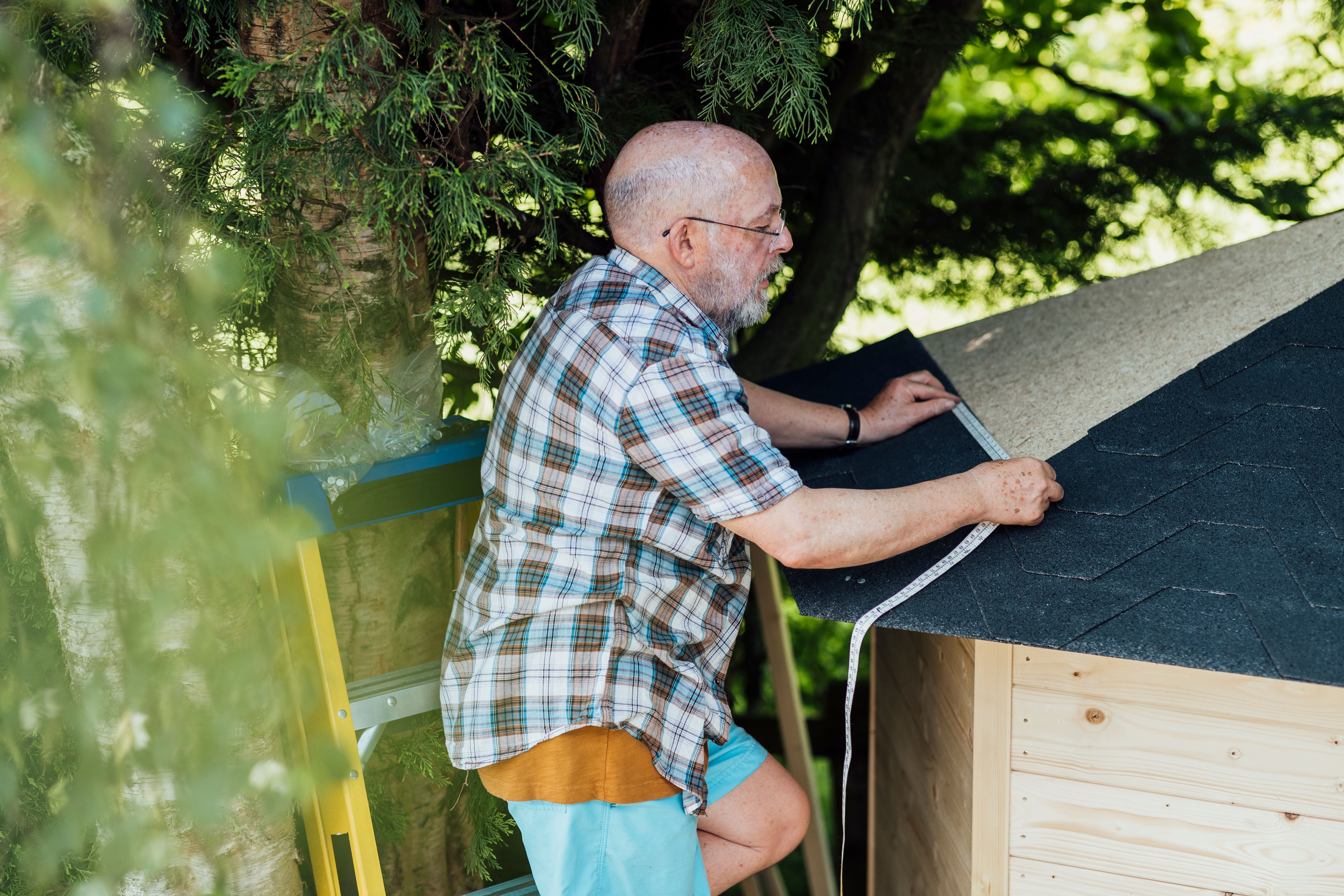 man installing shed
