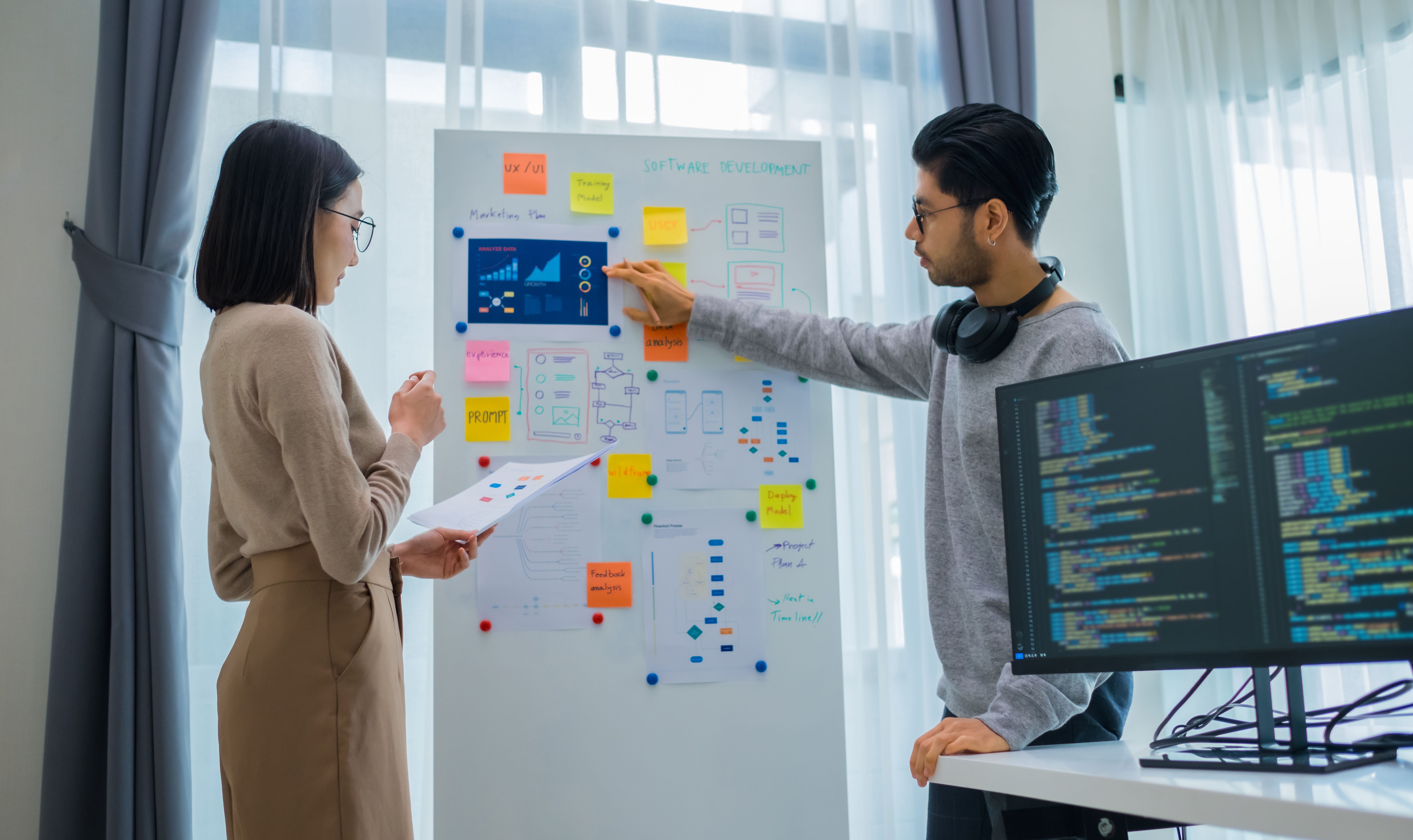 Developer team present project interface design with board and solving problem at office