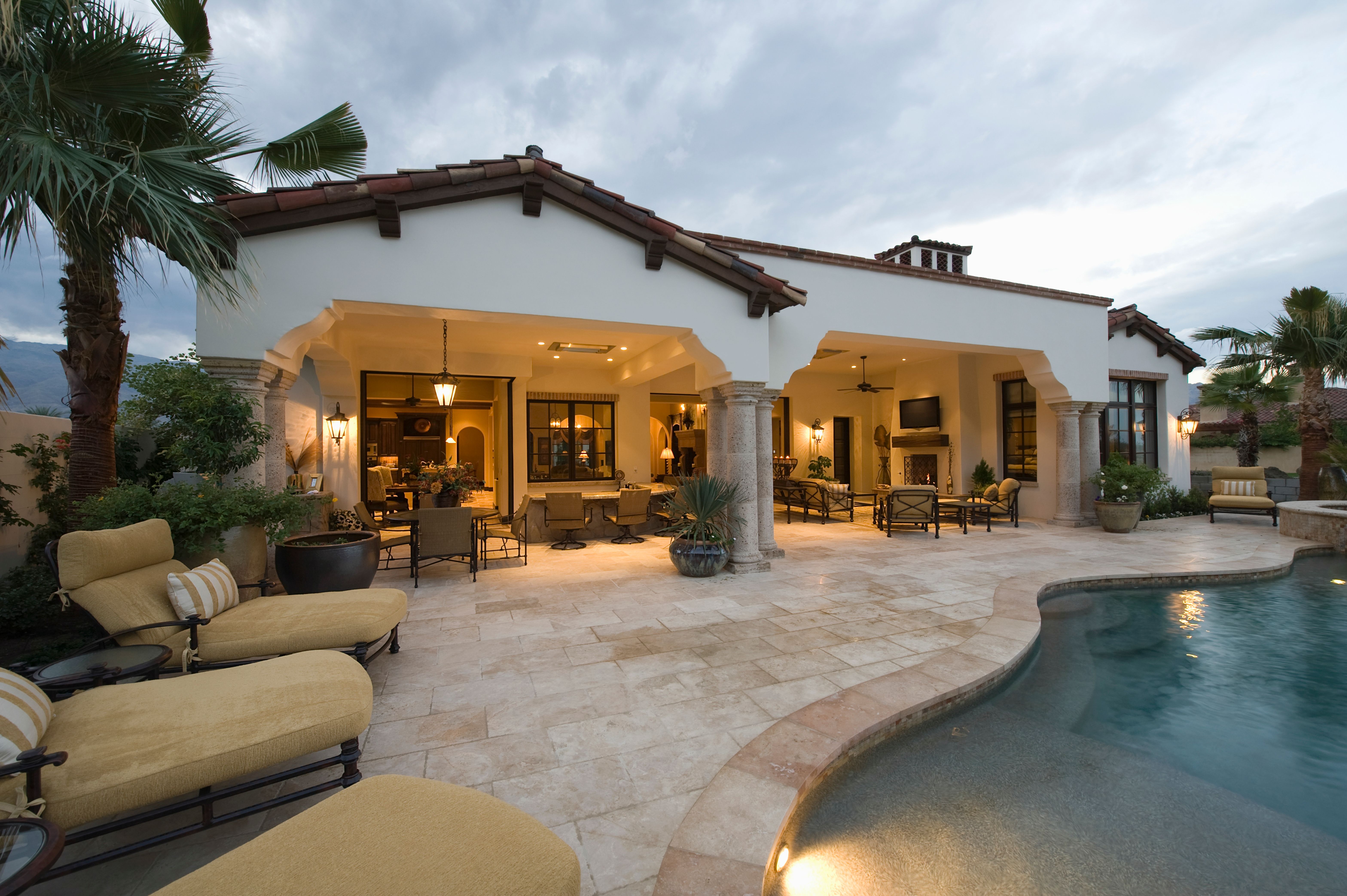 Sunloungers At Poolside Of Modern House
