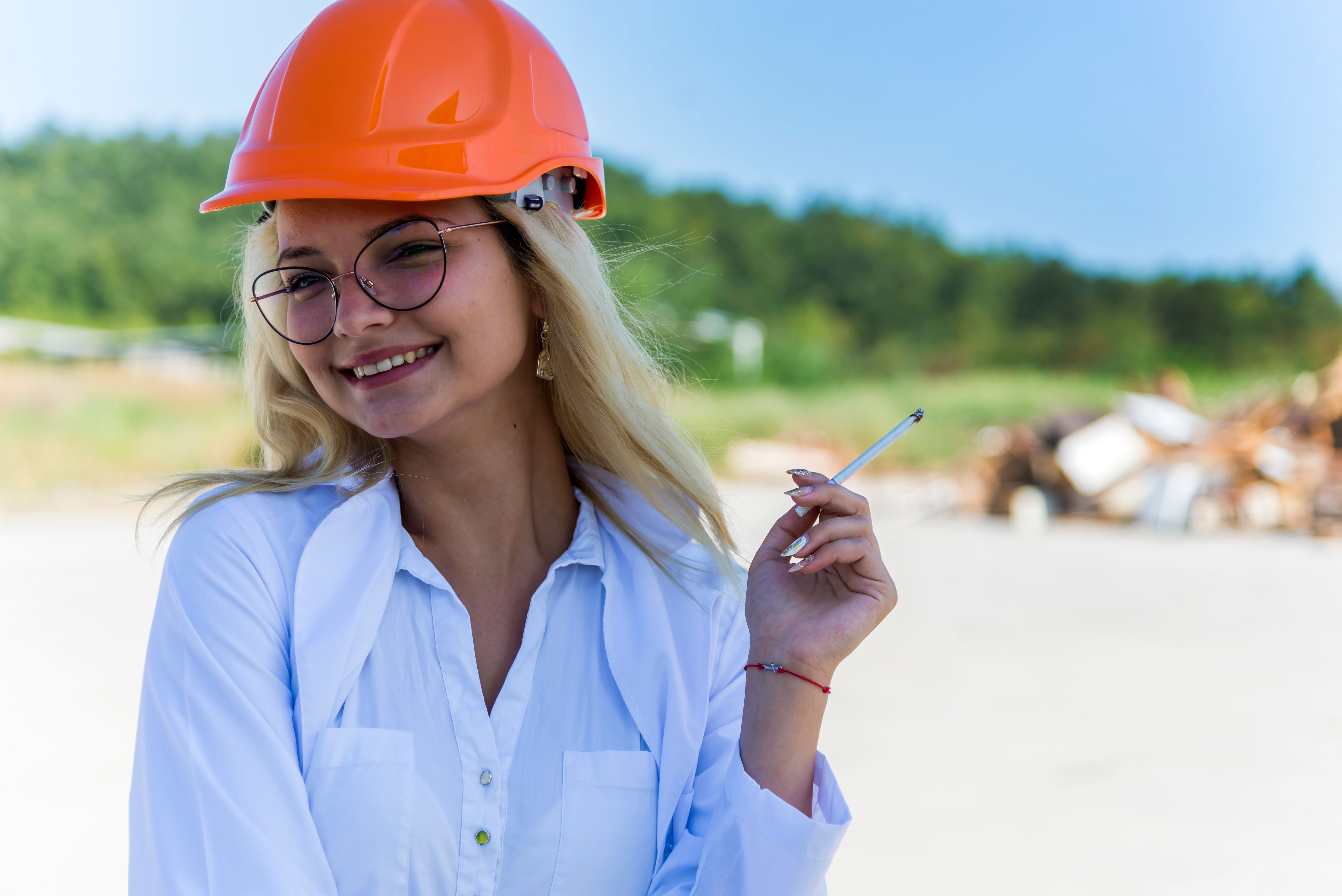 Portrait of a young female engineer with a helmet Portrait of a young female engineer with a helmet