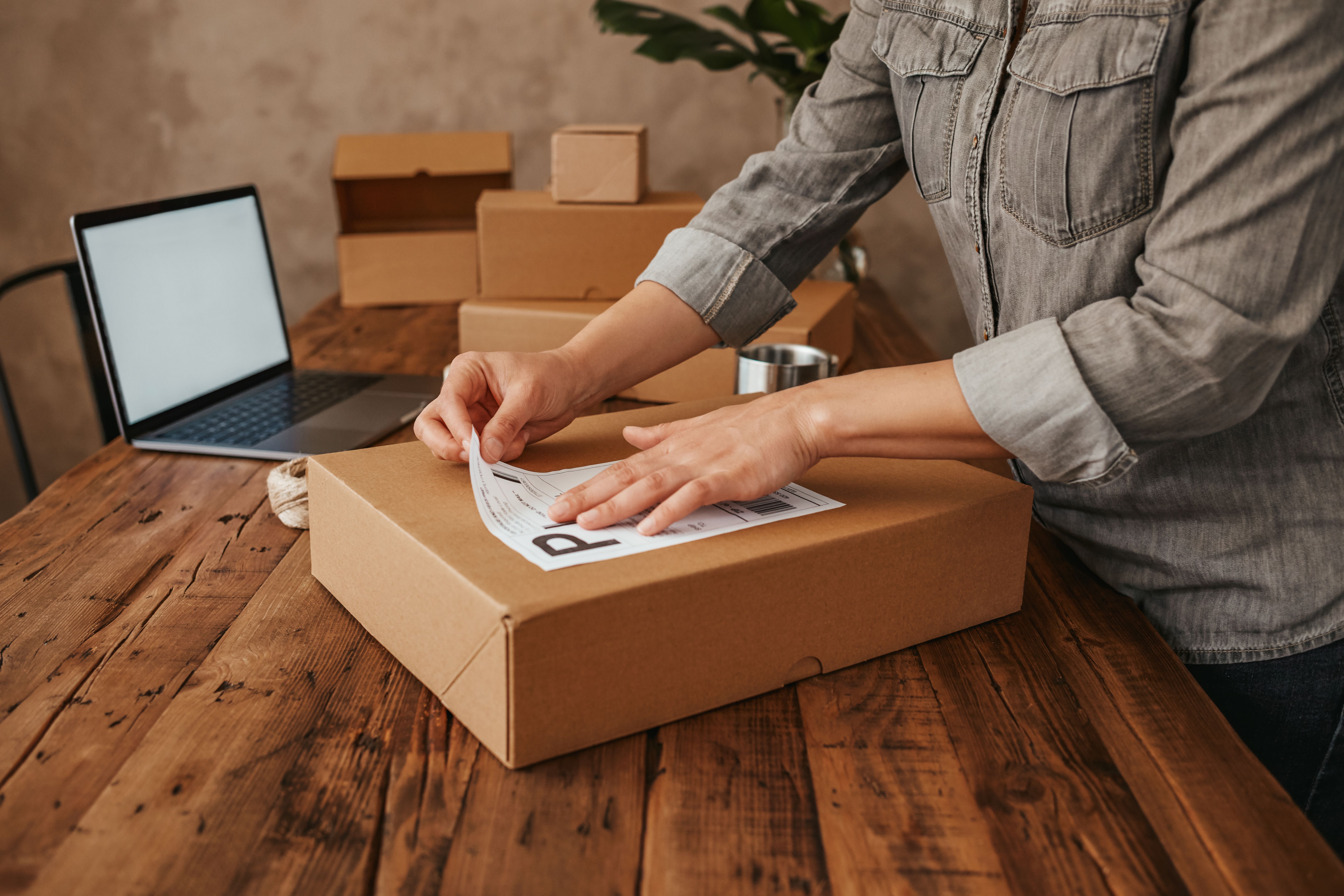 Female entrepreneur preparing the shipment for delivery. Small Business Owner Stock Photo