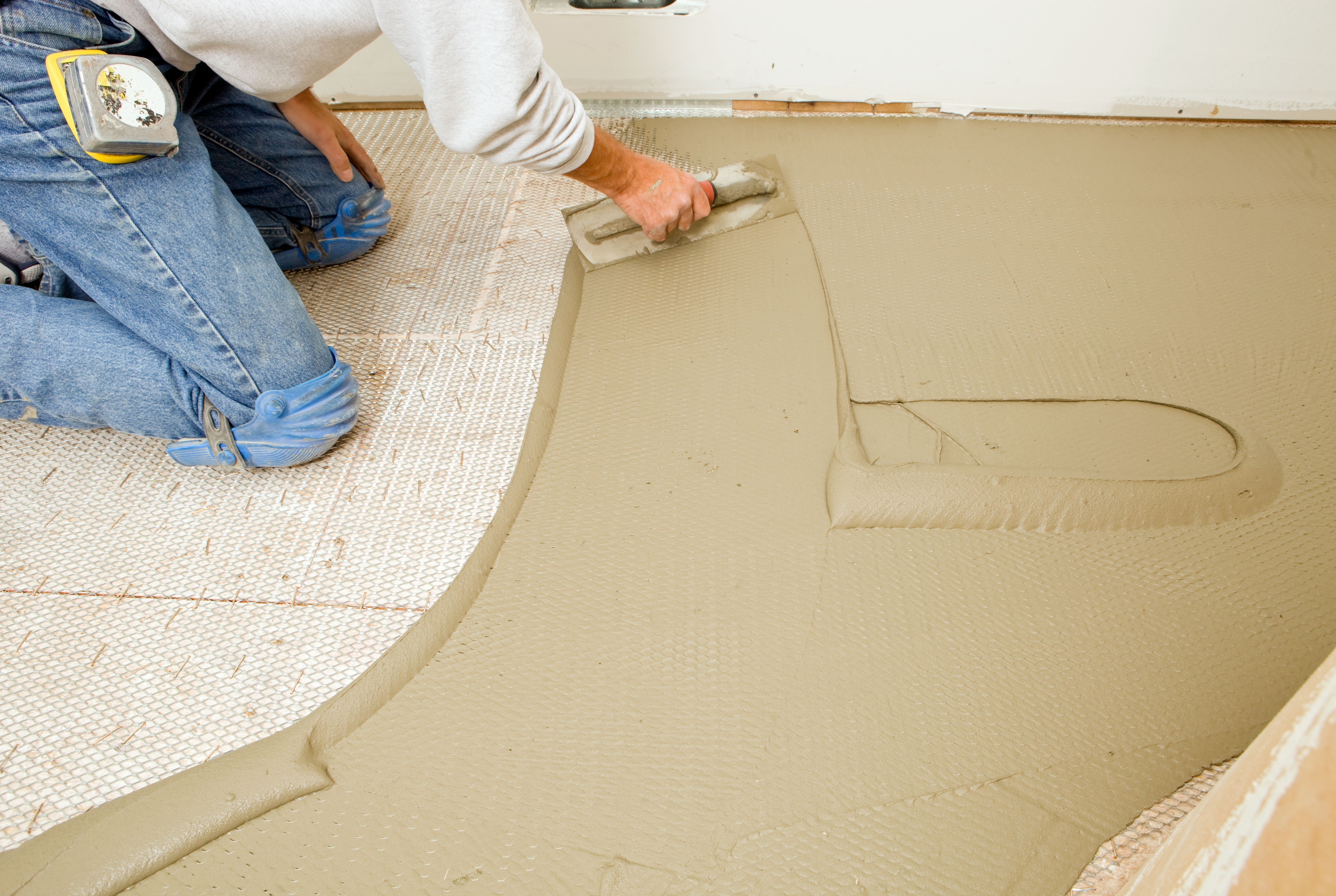 Tile Setter Troweling Mortar on Mesh Subfloor