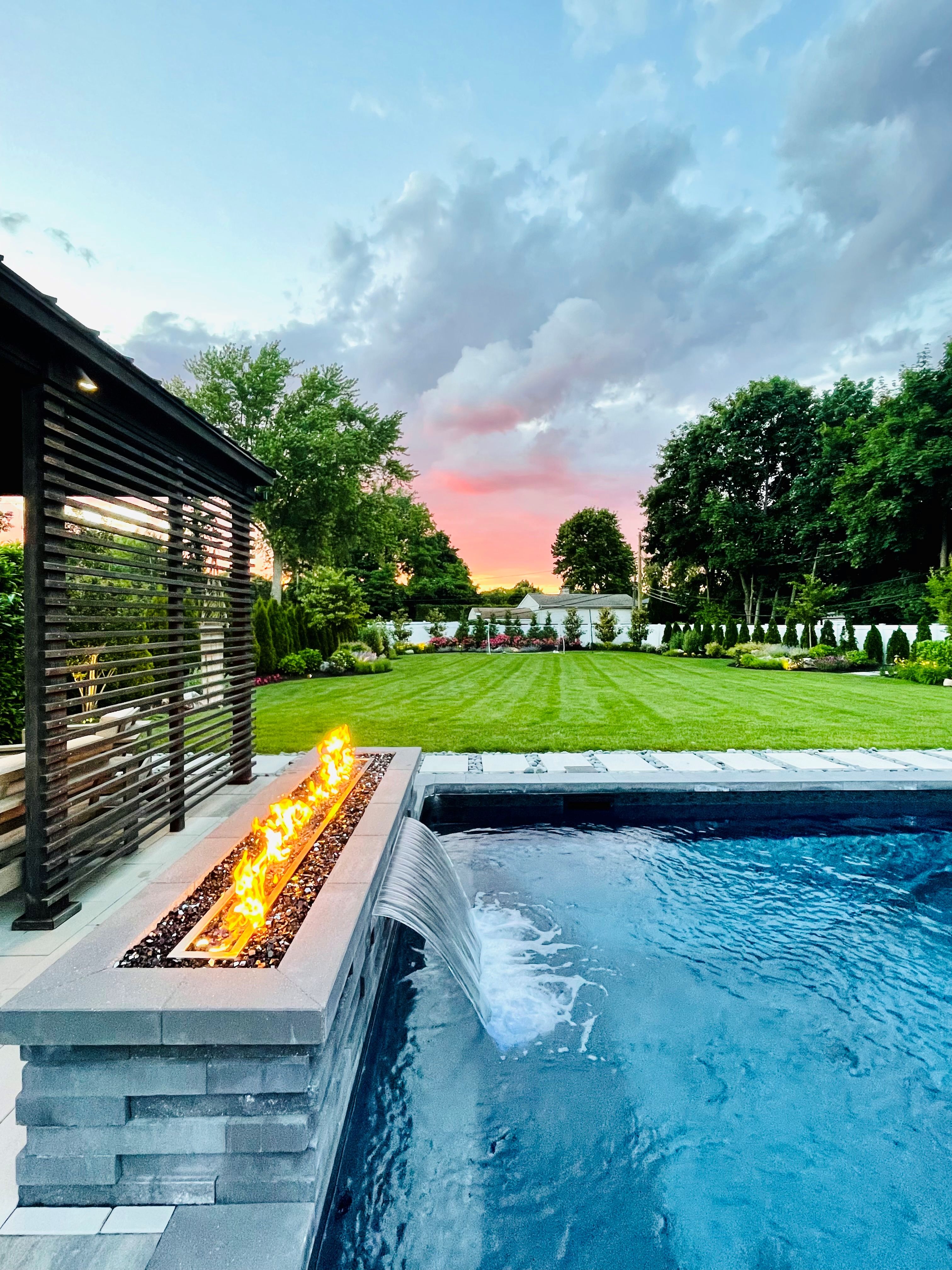 Gorgeous modern backyard at sunset, perfect indoor, outdoor and landscaping garden lighting design and aesthetics