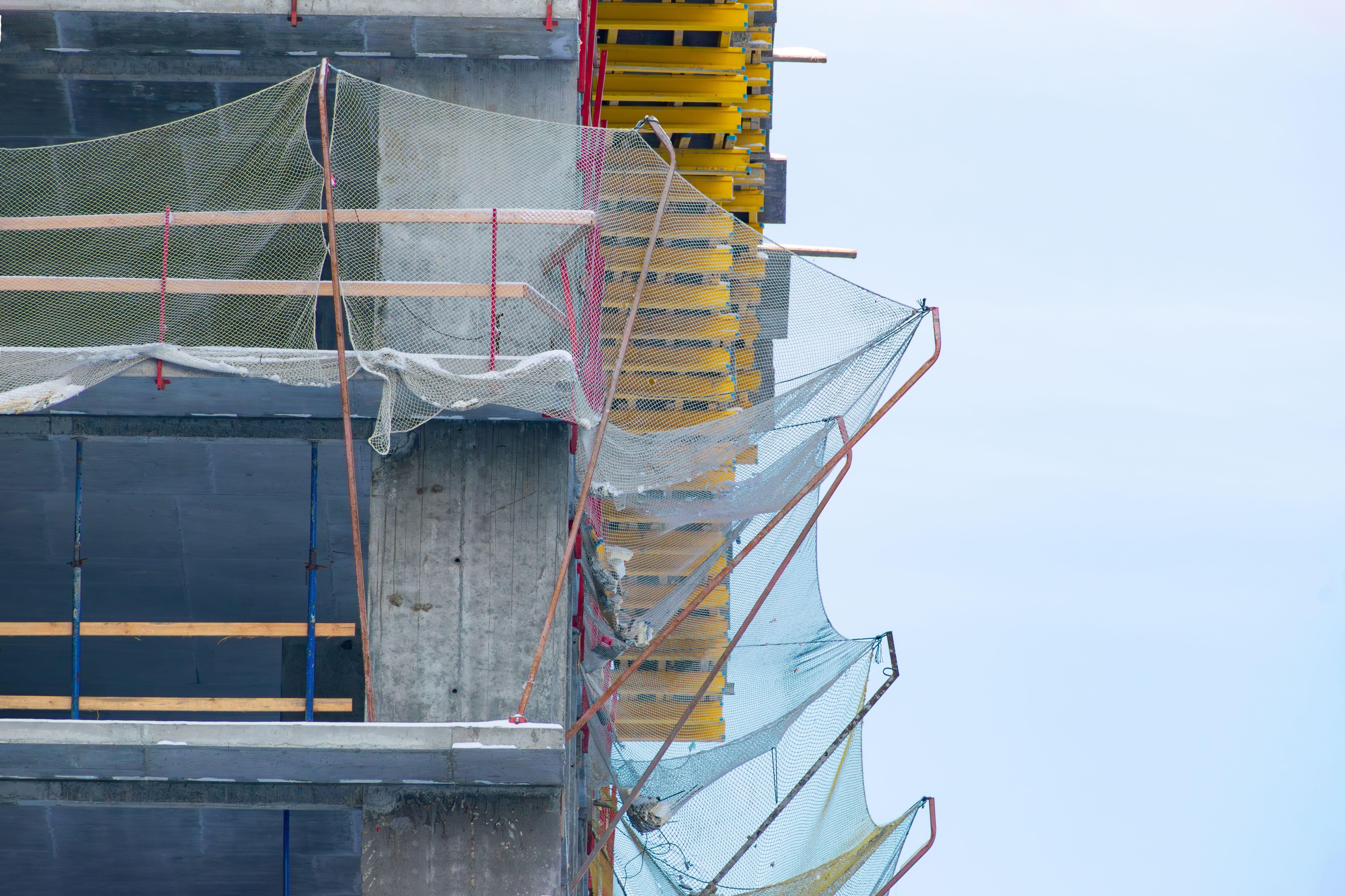 protective catching mesh on a building under construction protective catching mesh on a building under construction